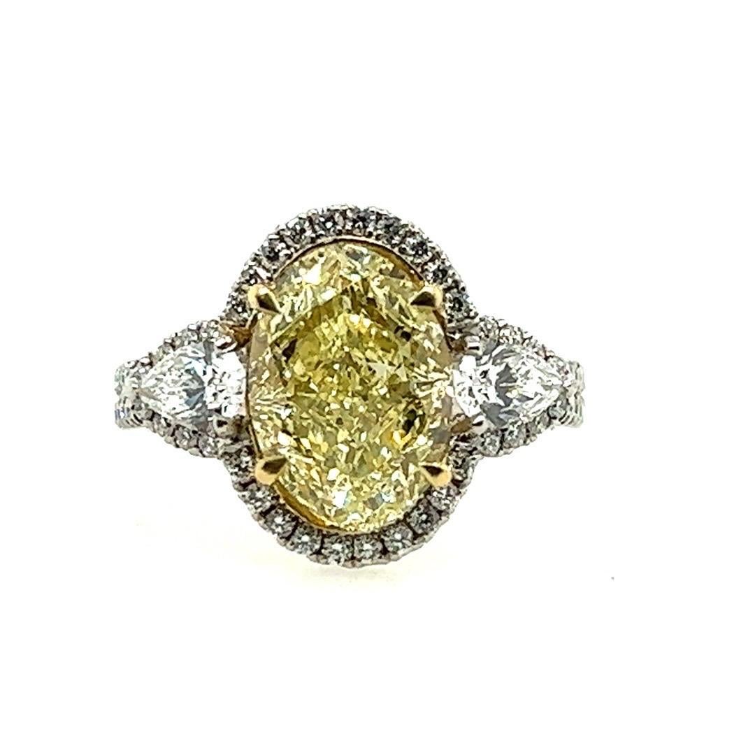 Modern Platinum 3.16ct Oval GIA Certified Natural Yellow VVS Diamond Engagement Ring For Sale