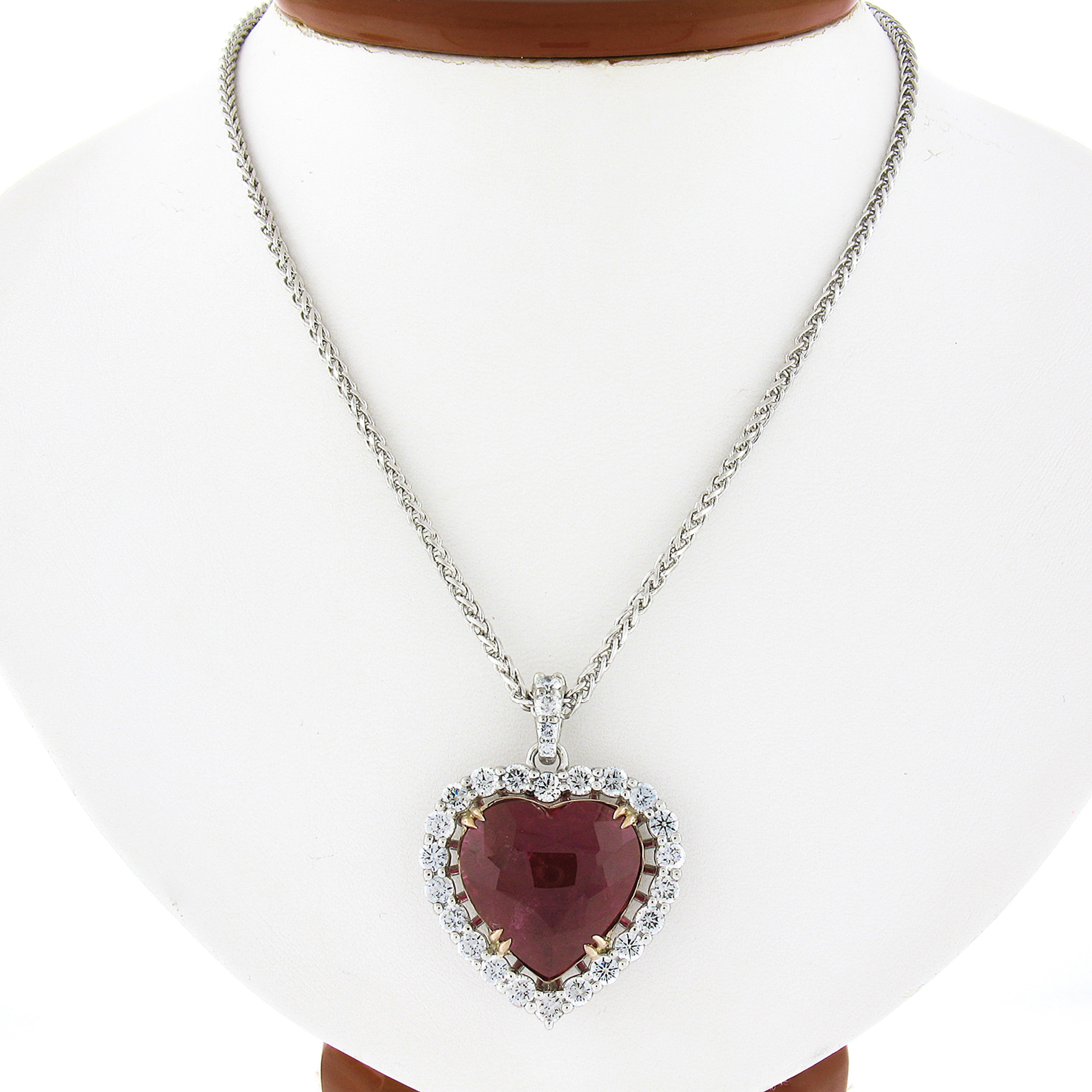 Up for sale is this incredible statement piece, custom designed and newly crafted by Badis Jewelers. The necklace features a large, GIA certified heart shape tourmaline stone that displays the finest and most mesmerizing purplish red color that is