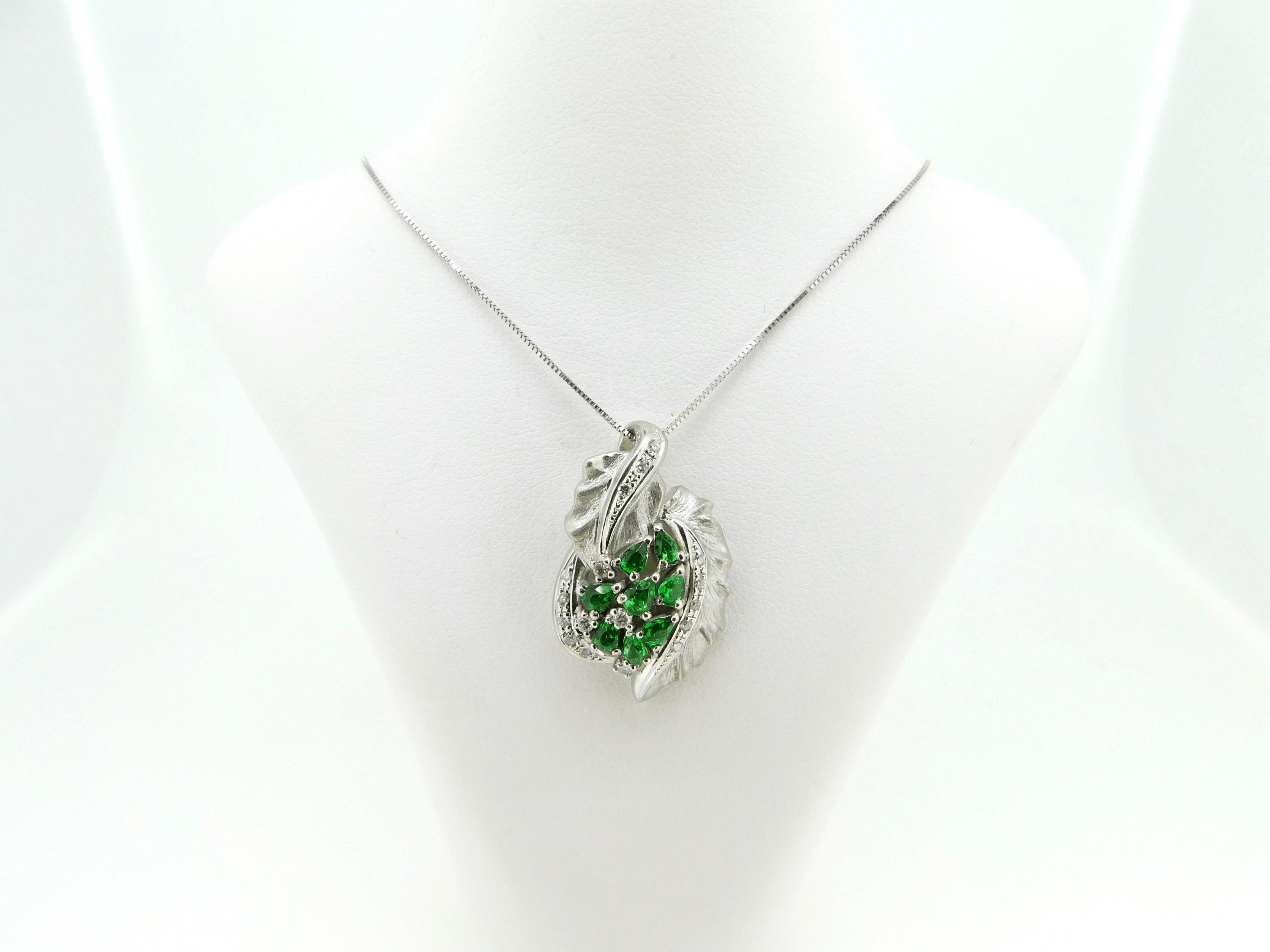 Platinum 3.50ct Genuine Natural Tsavorite Garnet and Diamond Pendant (#J4374)

Platinum tsavorite garnet and diamond leaf pendant with 14k chain. There are eight pear shape tsavorite garnets weighing 3.5 carats total. The garnets have fine grass