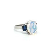 Platinum 3.89ctw Oval Cabochon Jelly Opal & Blue Emerald Cut Sapphire Sides Ring