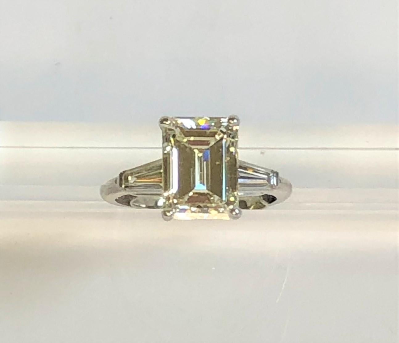 WOW this a great ring!- GIA Certified!!
3-stone platinum mounting with approximately 3.80 total diamond weight (estimated).
Handmade with serial number 35007 inside band
Middle emerald cut diamond approximately 10.6 X 7.5 X 5.06mm, approximately