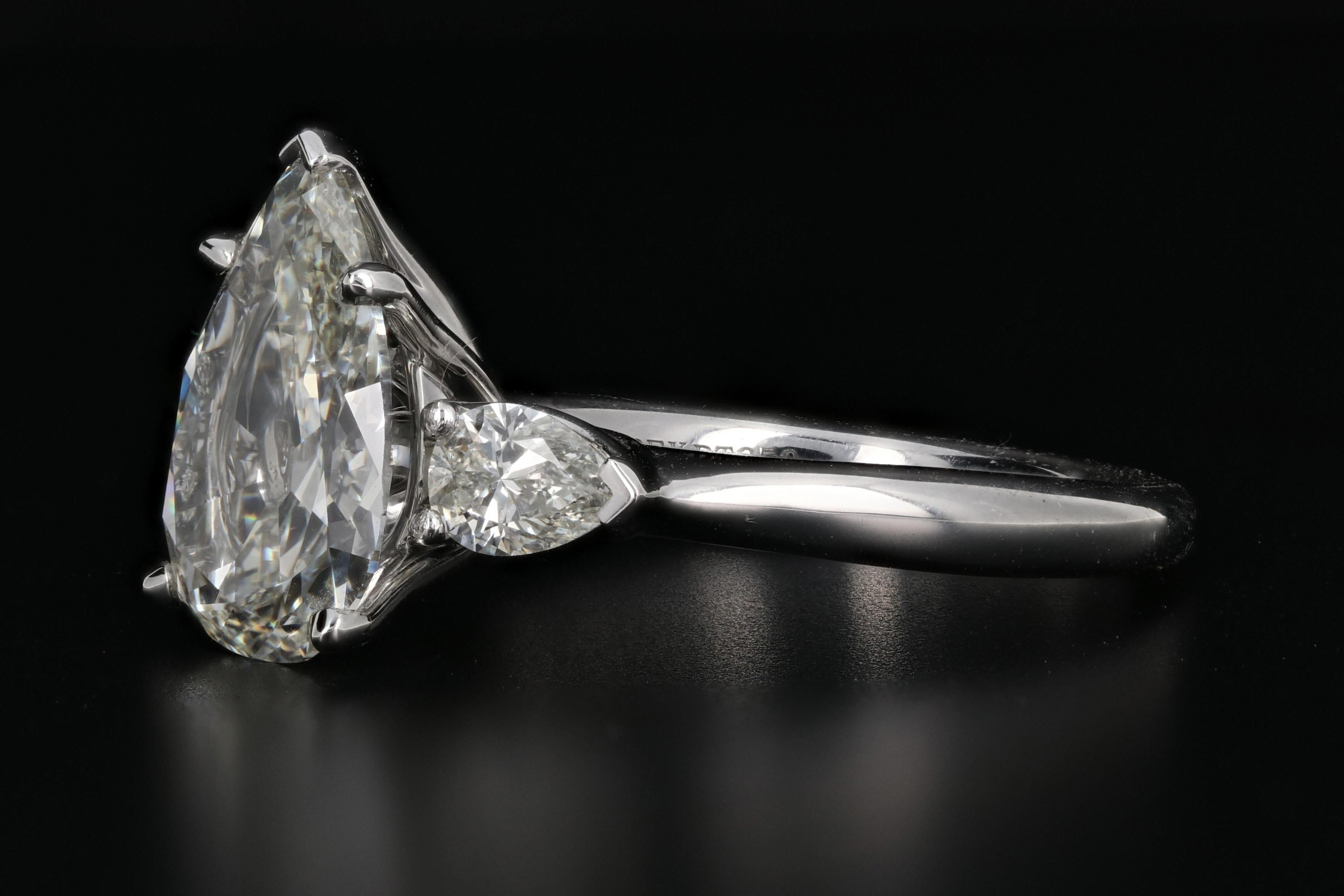 Hallmarks: APEX PT950

Primary Stone: Pear Cut Diamond

Diamond Measurements: 13 x 9.3 x 3.9mm

Carat Weight: 3 carats total

Color/Clarity: J/K - Vs1/2

Size: 6.75

Weight: 8.24 Grams

Hight off Finger: 8.65mm

Ring Width: 13.48mm

Condition: