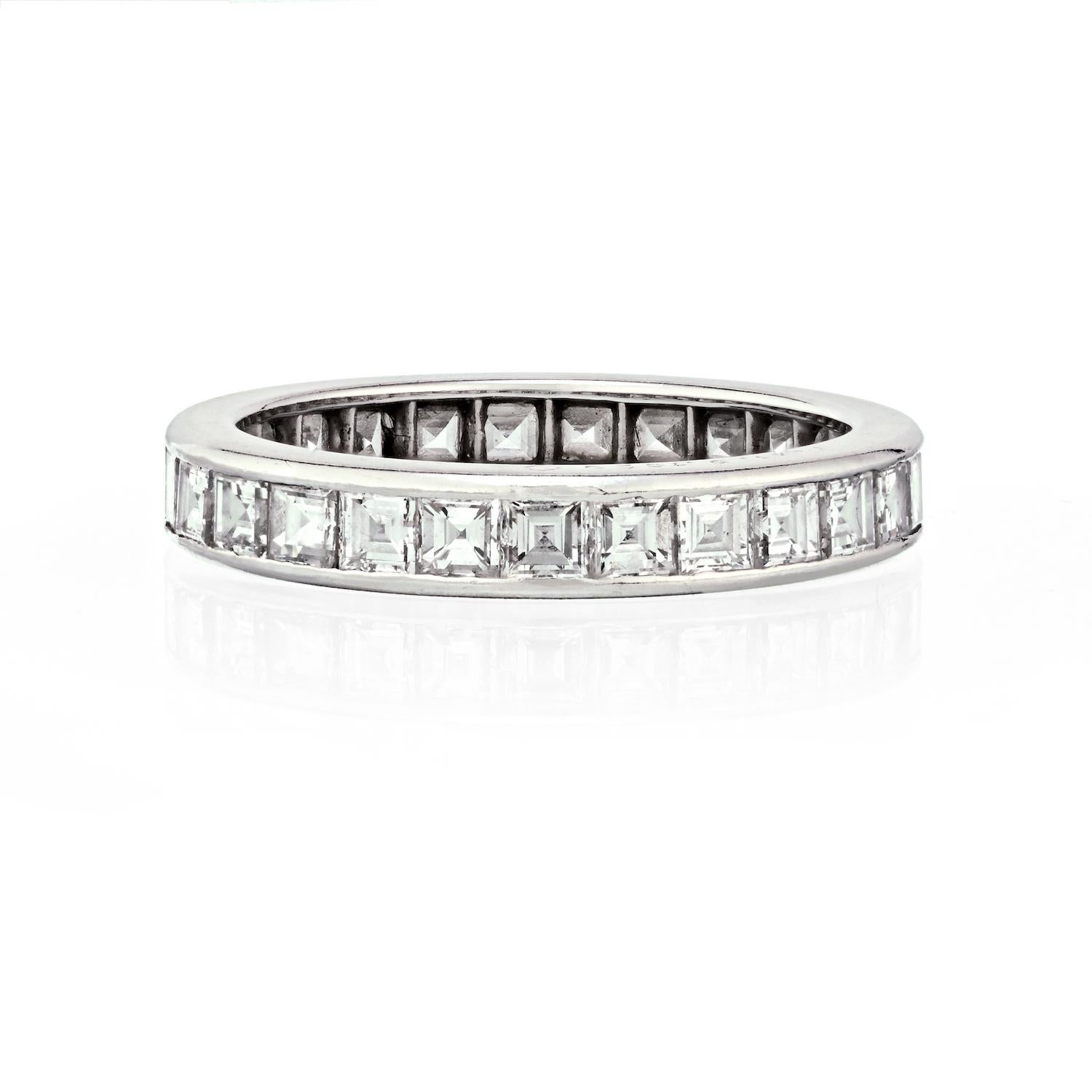 This is a stunning channel set carre cut diamond eternity ring. It is crafted in luxurious platinum, featuring a remarkable channel setting, showcases a dazzling array of carre cut diamonds. 

With a total weight of 4 carats, these diamonds radiate