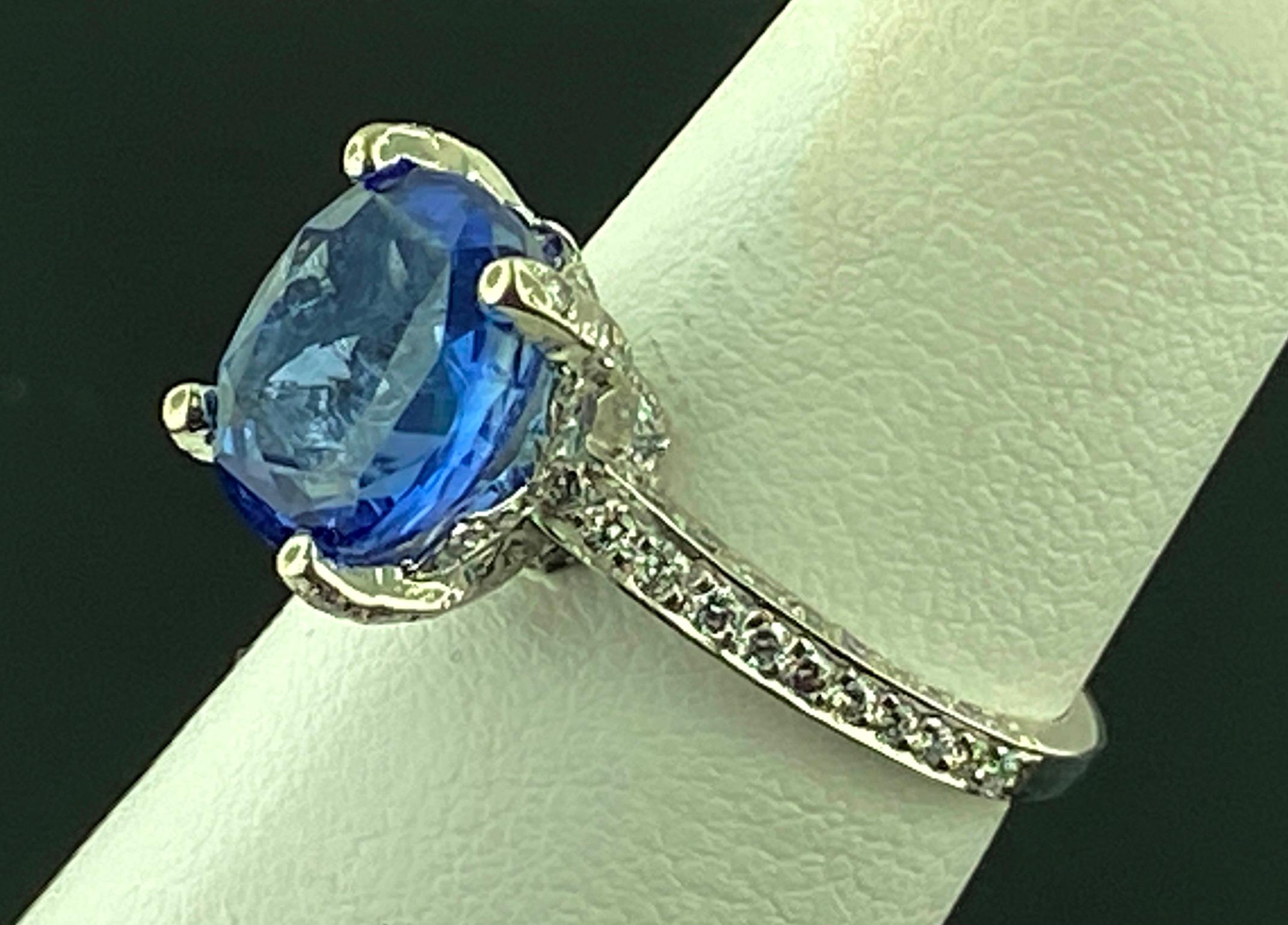 Set in Platinum, weighing 5 grams, is a 4.06 carat Oval Cut Blue Sapphire with 114 Round Brilliant Cut diamonds set in the mounting with a total diamond weight of 0.70 carats.  Ring Size is 6.