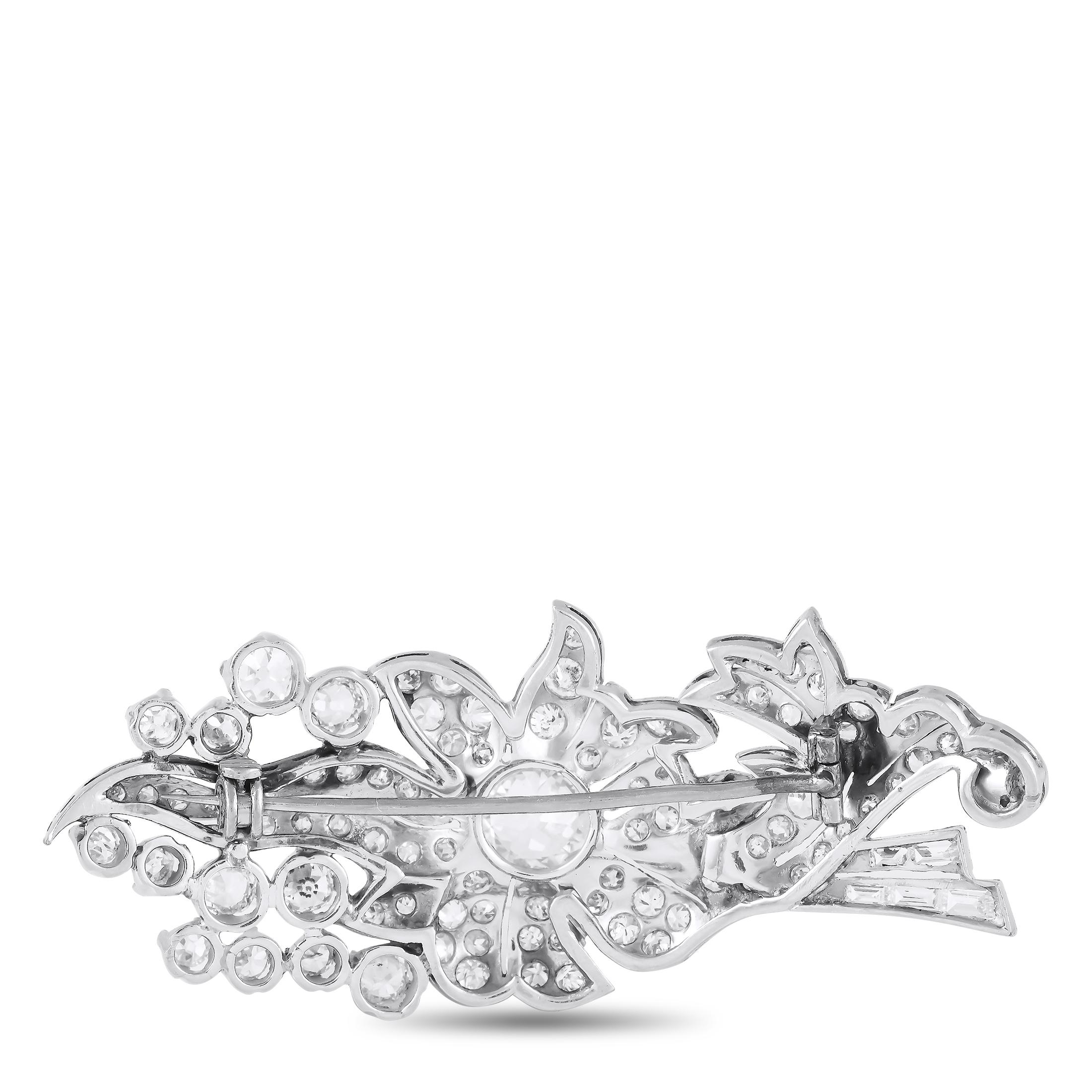 Add a touch of sophistication to any ensemble with this exquisite brooch. A 1.61 carat round-cut Diamond makes a statement at the center, while additional Diamonds totaling 2.70 carats provide plenty of extra sparkle. The floral motif and additional