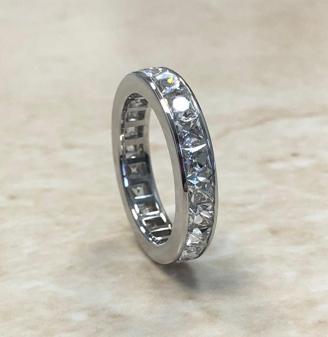 This is a stunning 4.50 Carats channel set swiss cut diamond eternity band crafted in platinum. Seamless channel setting is made in the best handmade style where there are no spaces between the stones. The custom ring that looks oh so