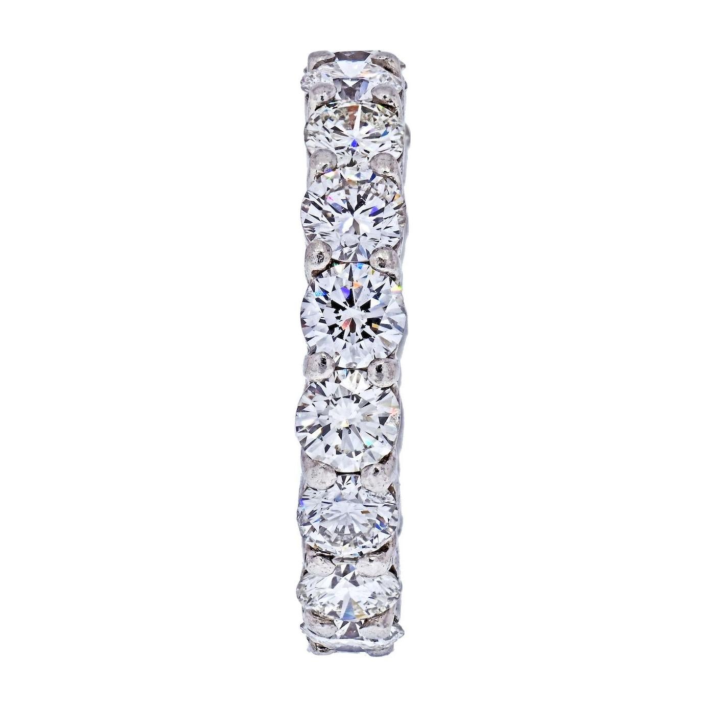 Classic eternity band crafted in platinum mounted with round brilliant cut diamonds. 
Each diamond is about 0.27ct each. 
Quality G-H color, VS-SI clarity. 
Clean to the naked eye. 
Size 7 
Width: 4mm
