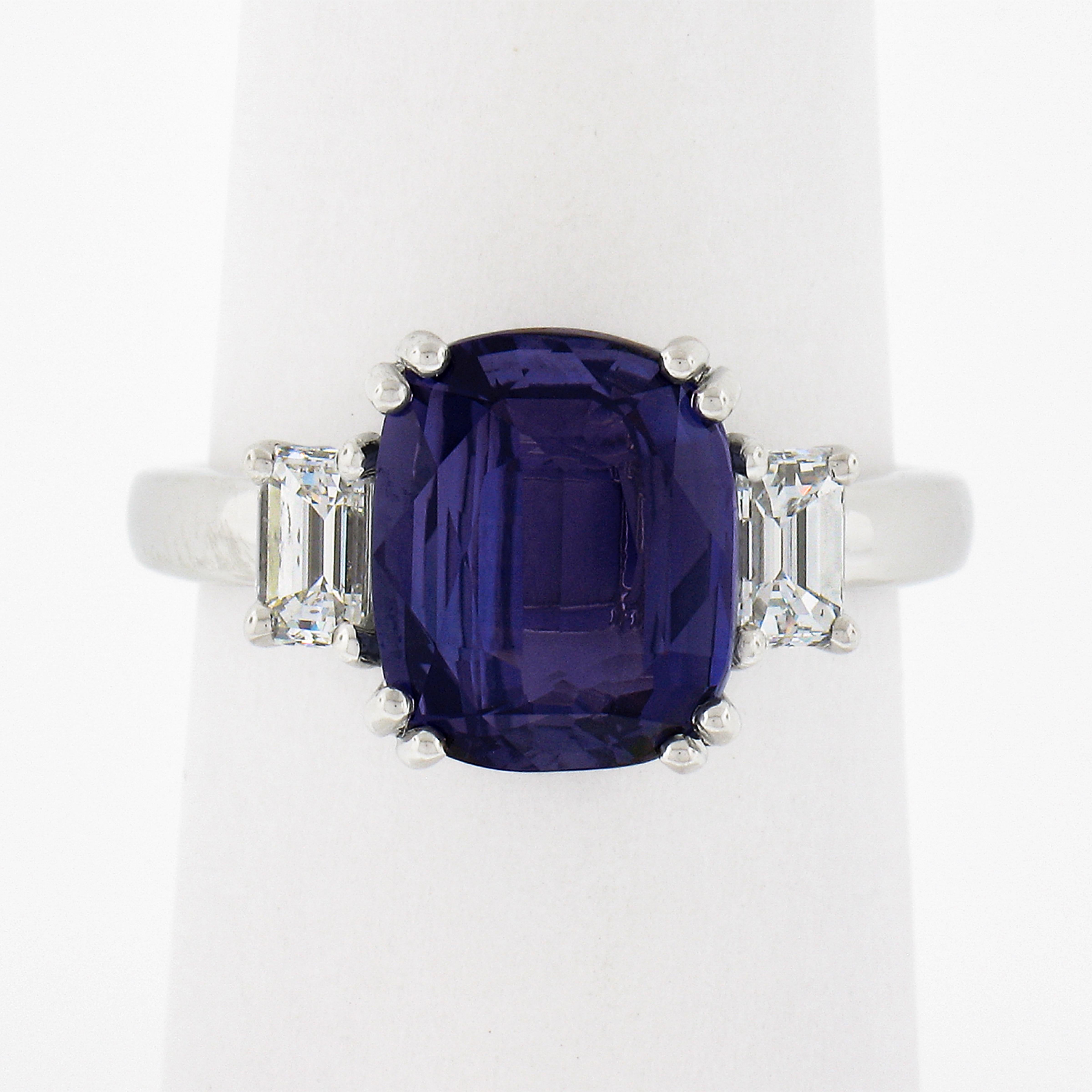 This very unique sapphire and diamond custom made engagement ring is crafted in solid platinum and features a gorgeous GIA certified, 4.06 carat cushion cut color change sapphire solitaire, neatly prong set in the center and flanked on either side