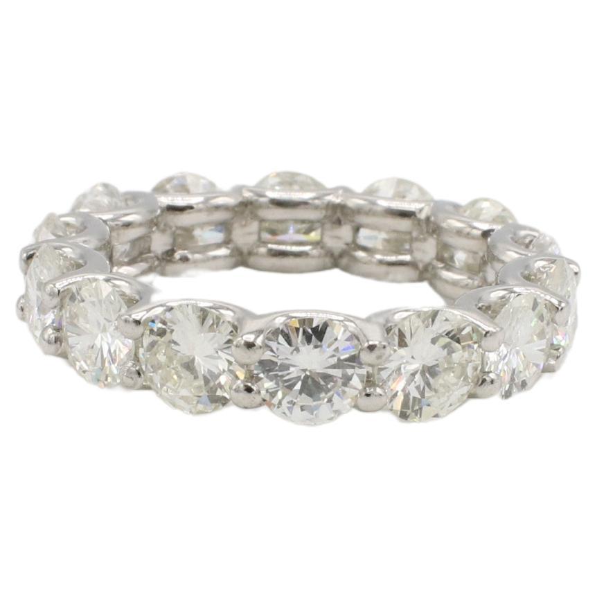 Platinum 4.88 Carat Round Natural Diamond Eternity Band Ring 
Metal: Platinum
Weight: 7.6 grams
Diamonds: 4.88 CTW H-J VS round natural diamonds, 14 stones
Width: 4.7mm
Size: 6.25 (US)
