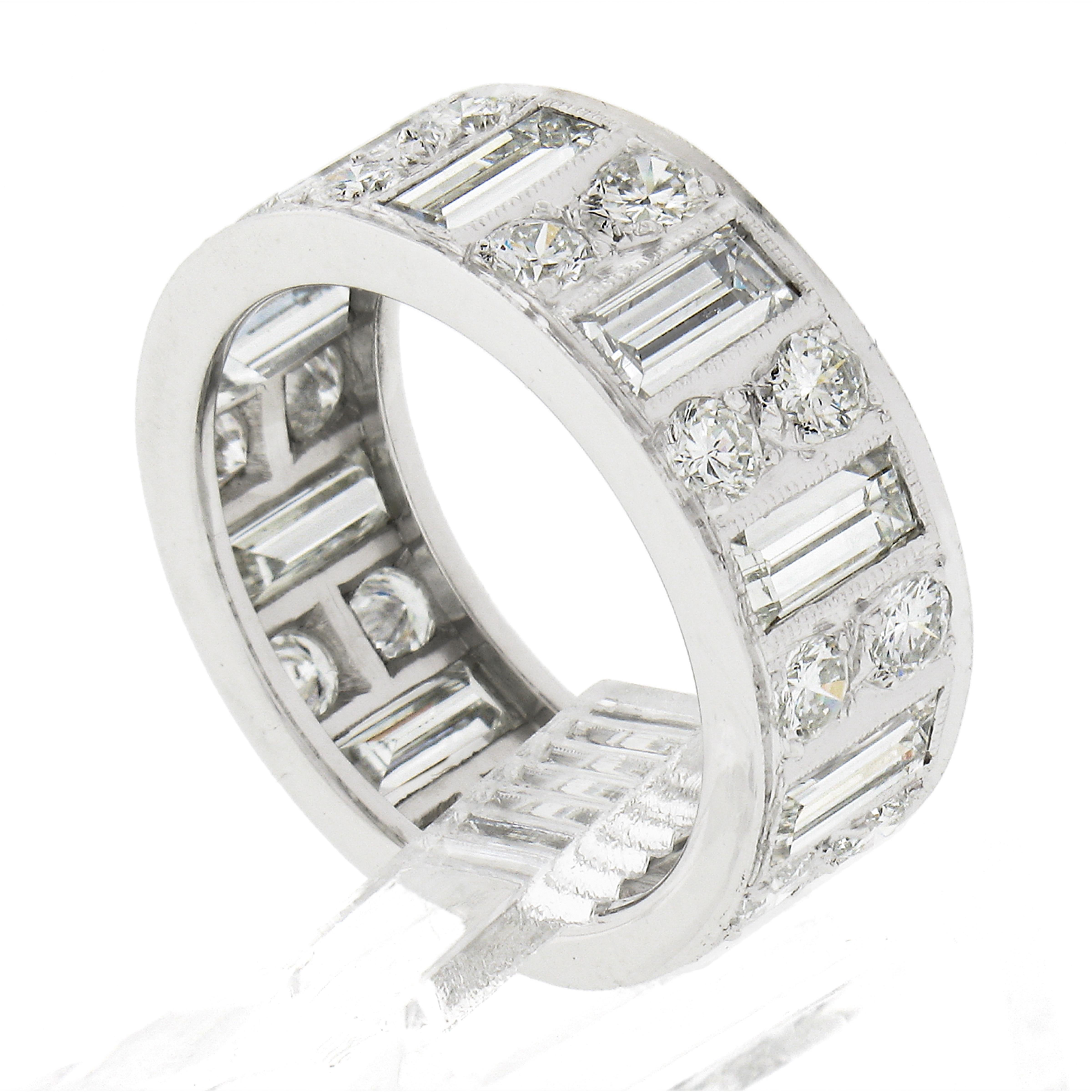 This absolutely stunning and very well made vintage diamond eternity band is crafted in solid platinum. It features very fine quality straight baguette cut diamonds neatly Milgrain bezel set that alternate with round brilliant cut pave set diamonds.