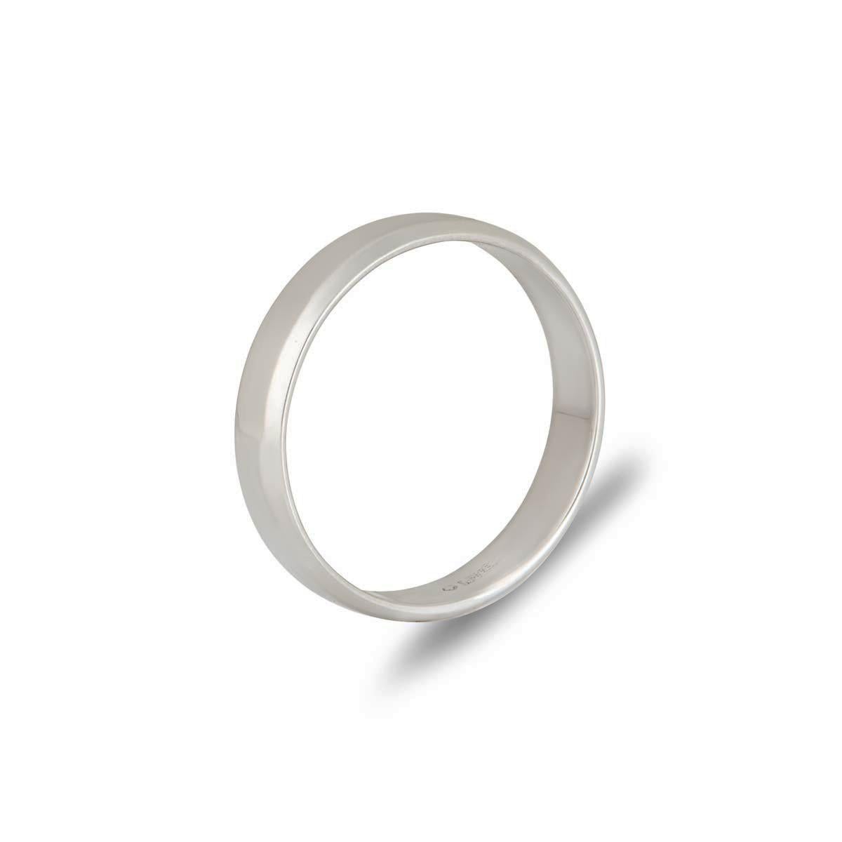 A contemporary platinum wedding band. The band measures 4mm in width, features a bevelled edge and displays a high polish finish. The ring has a gross weight of 4.15 grams and is currently a size UK M½ - EU 52½ but can be adjusted for the perfect