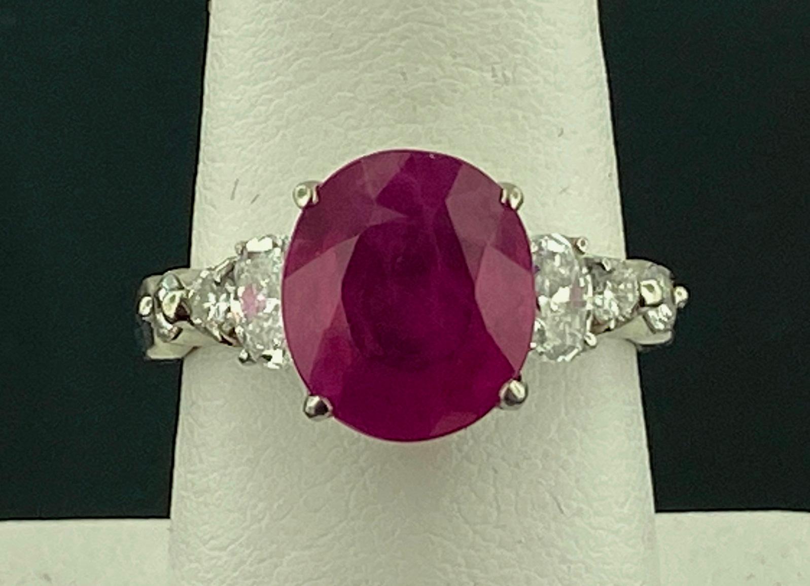 Set in Platinum, weighing 10.21 grams, is one 5.48 carat Oval Cut Ruby with 2 Oval Cut diamonds weighing 0.84 carats, Color Grade of: F-G, Clarity grade of: VS, plus 4 Round Brilliant Cut diamonds weighing 0.35 carats, Color Grade of: F-G, Clarity