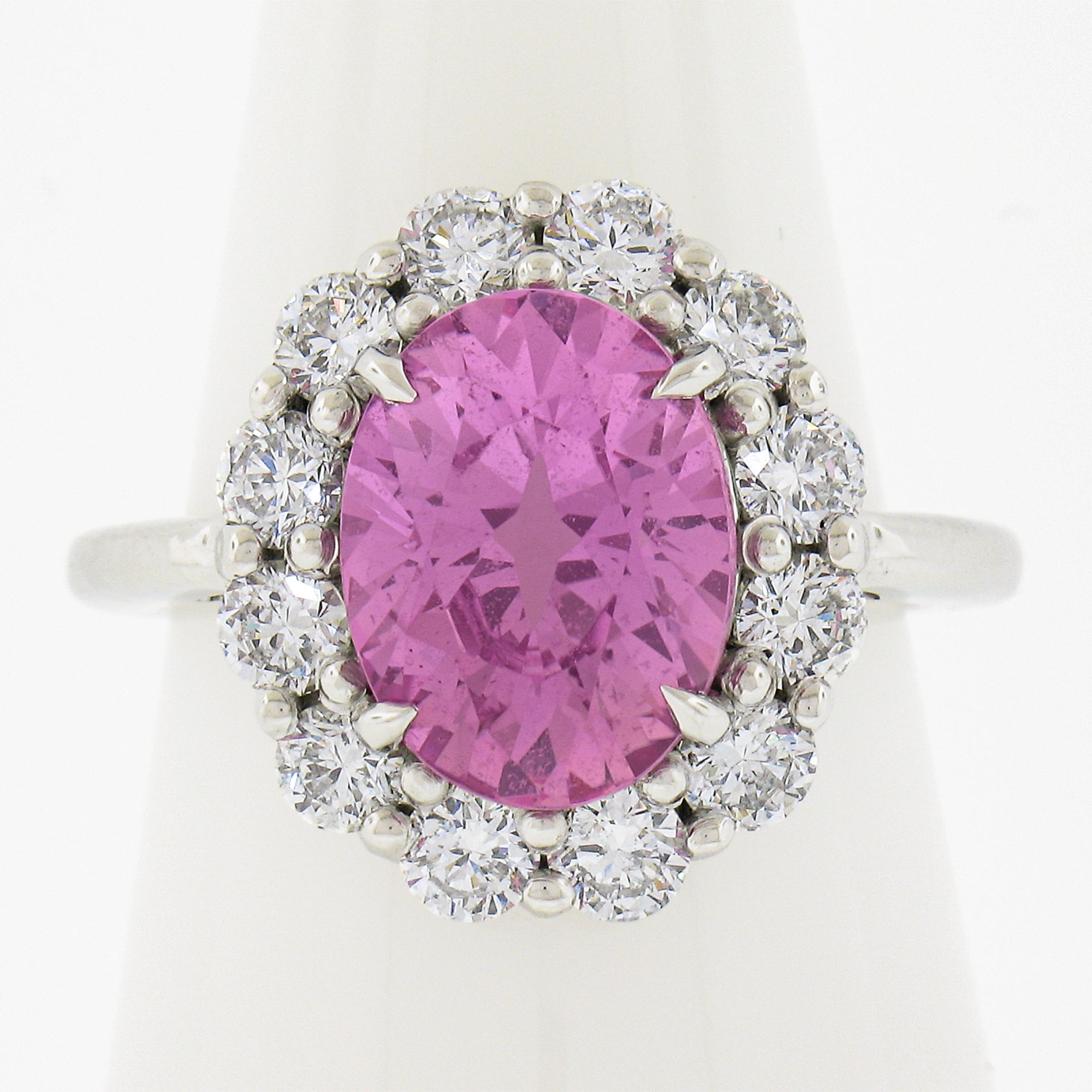 Your dream pink sapphire and diamond cocktail ring is here! 4.31 carats of pure pink fire graded by GIA and surrounded by a classic halo of large and brilliant round diamonds that total 1.33 carats in weight. The GIA report guarantees that the