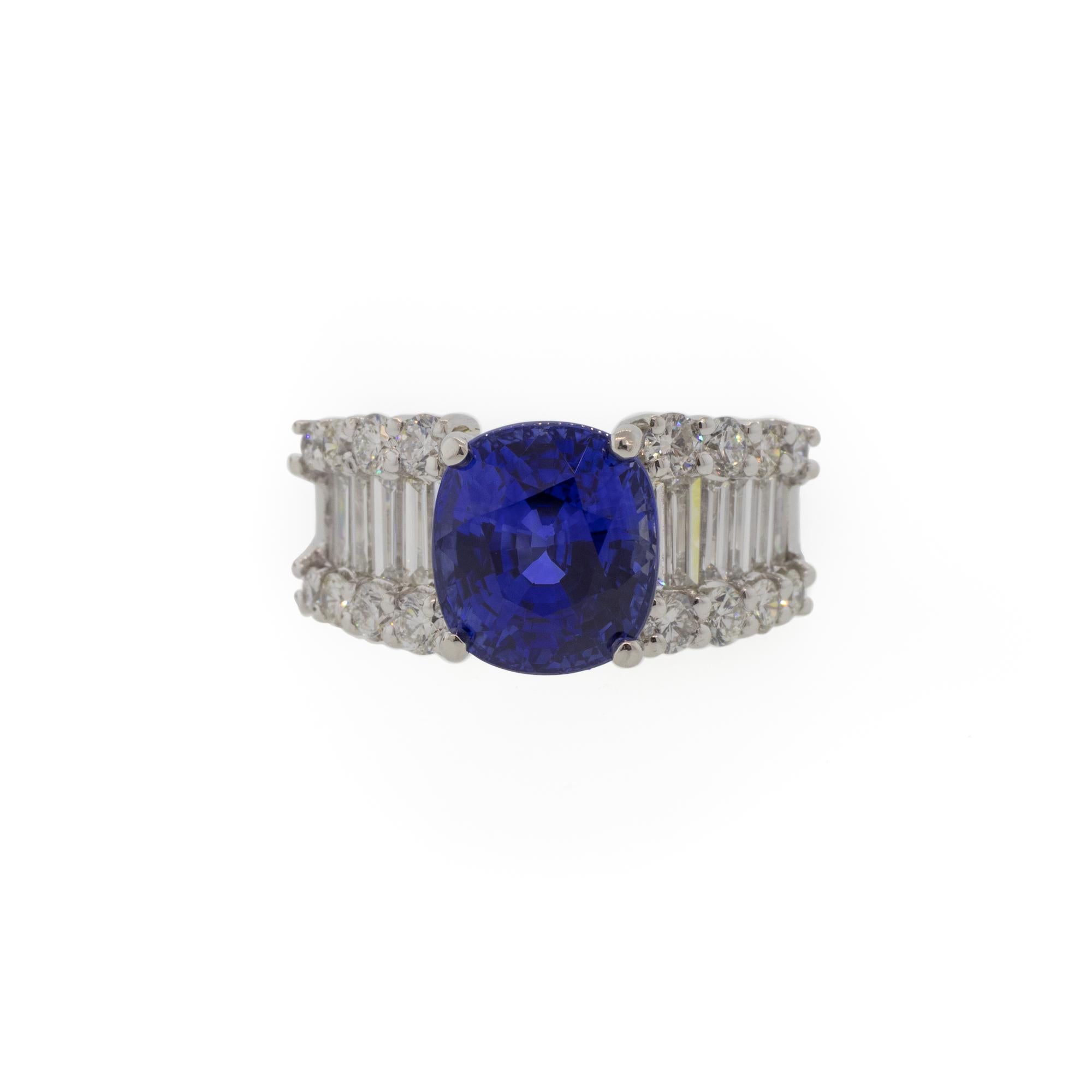 A glamorous vintage cocktail ring combining only the most beautiful components. The 5.85 carat cushion cut sapphire center gemstone originates from Sri Lanka and has undergone a standard heat treatment to bring out an intense true blue color. The