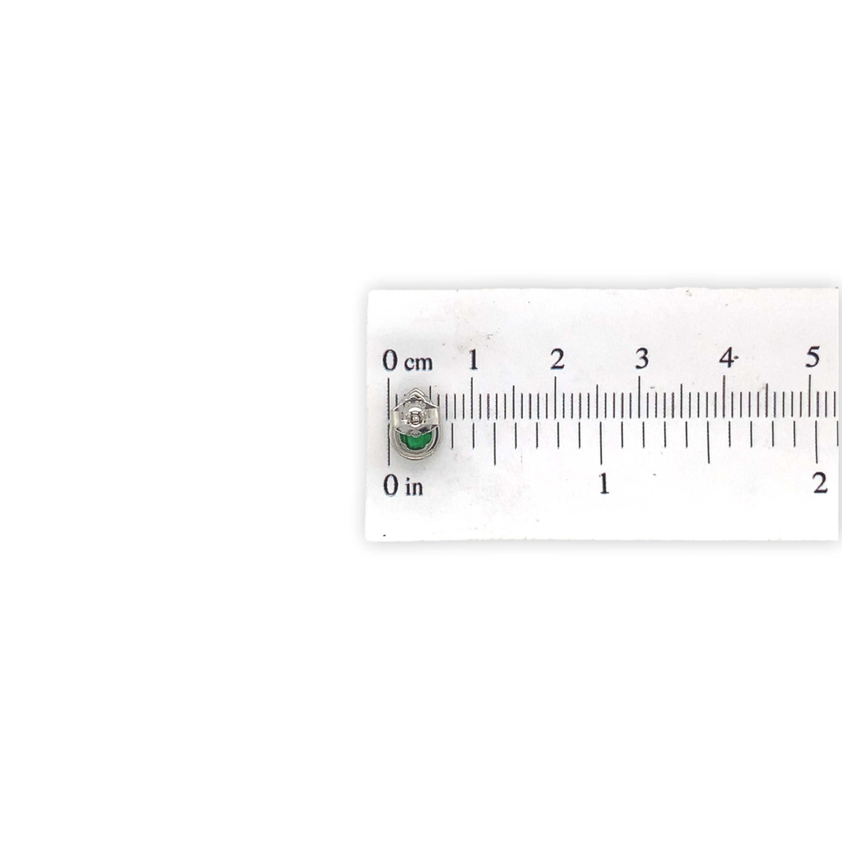 Platinum .60ct tw Emerald and Diamond Halo Stud Earrings For Sale 1