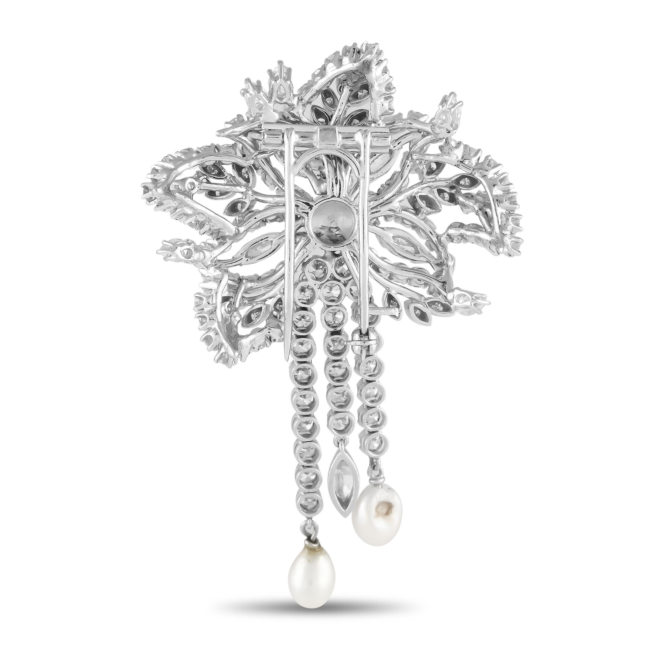 This impeccably crafted Platinum brooch will add a touch of sparkle to any ensemble. Diamonds with a total weight of 6.23 carats allow it to seemingly radiate light, while pearl accents provide the perfect finishing touch. It measures 2.65 long by