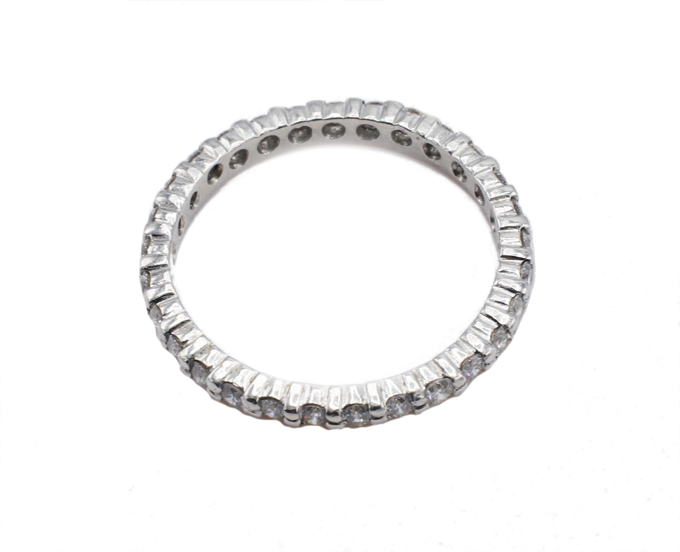 Modern Platinum .65 Carat Round Natural Diamond Eternity Band Ring For Sale