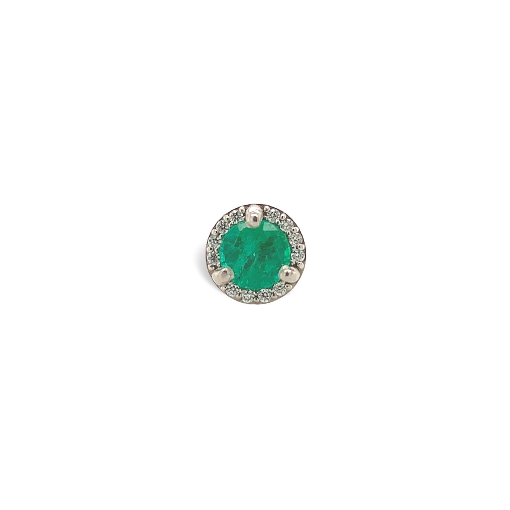 A pair of platinum genuine earth mined emerald stud earrings with diamond halos. The round cut emeralds measure about 4.3mm and have medium dark color and fine clarity. The emeralds weigh .65 carats total. There are 24 tiny round diamond accents