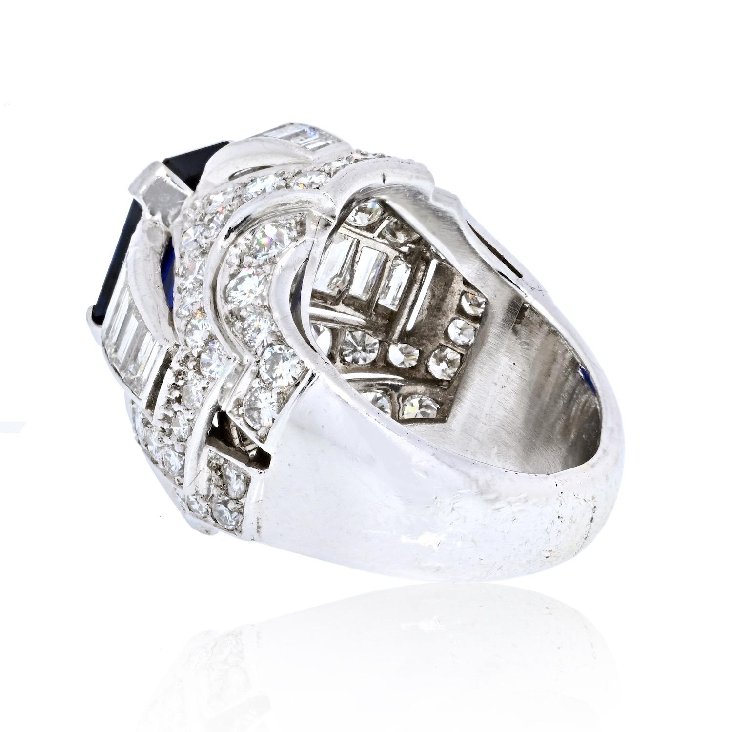 Estate diamond and sapphire ring crafted in platinum mounted with an emerald cut sapphire of a deep blue color, approx. 7 carats and diamonds of approx. 5.50cts. 
Diamond Shape: Round Cuts, Baguette Cuts
Diamond Quality: F-G color, VS-SI