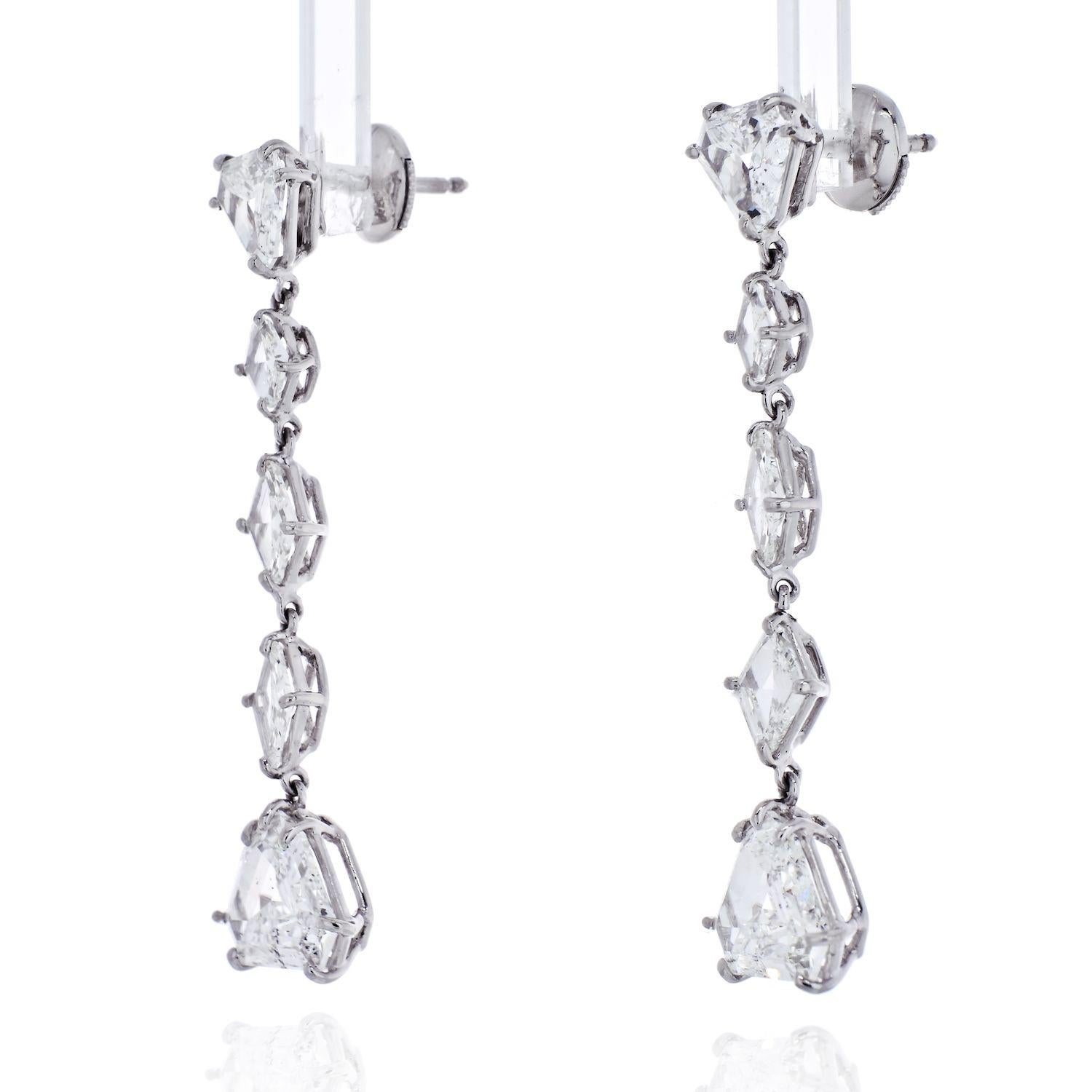 Platinum 7 Carat Fine Stone Dangling Diamond Earrings

Crafted in platinum these dangling earrings are manufactured with shield and kite-cut diamonds. 

Each earring contains 5 diamonds of about 3.50cttw. The total pair carat weight is about 7