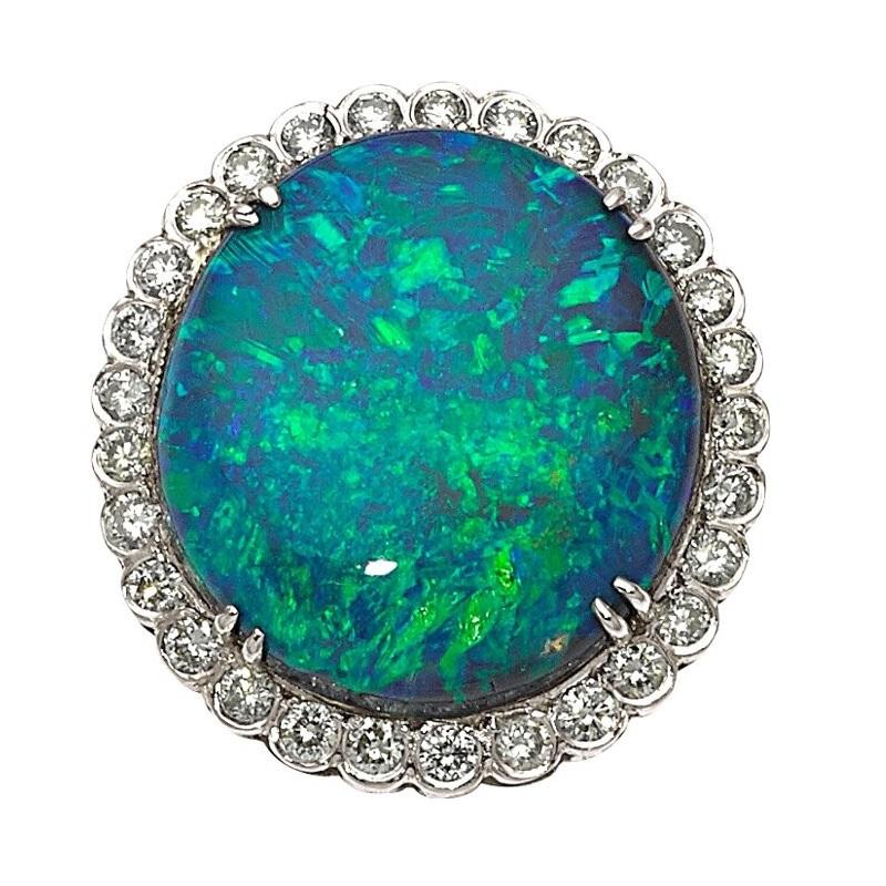 Platinum 7.5 ct Black Opal Cabochon Diamond Ring Size 6.25

Gorgeous Platinum Cocktail Ring
Features Gorgeous Black Opal Cabochon with Diamond Halo
Appx Dimensions of Opal = 18.4 x 16.75 x 4.64 mm
Appx Total Weight of Opal = 7.5 ct
Appx Diamond