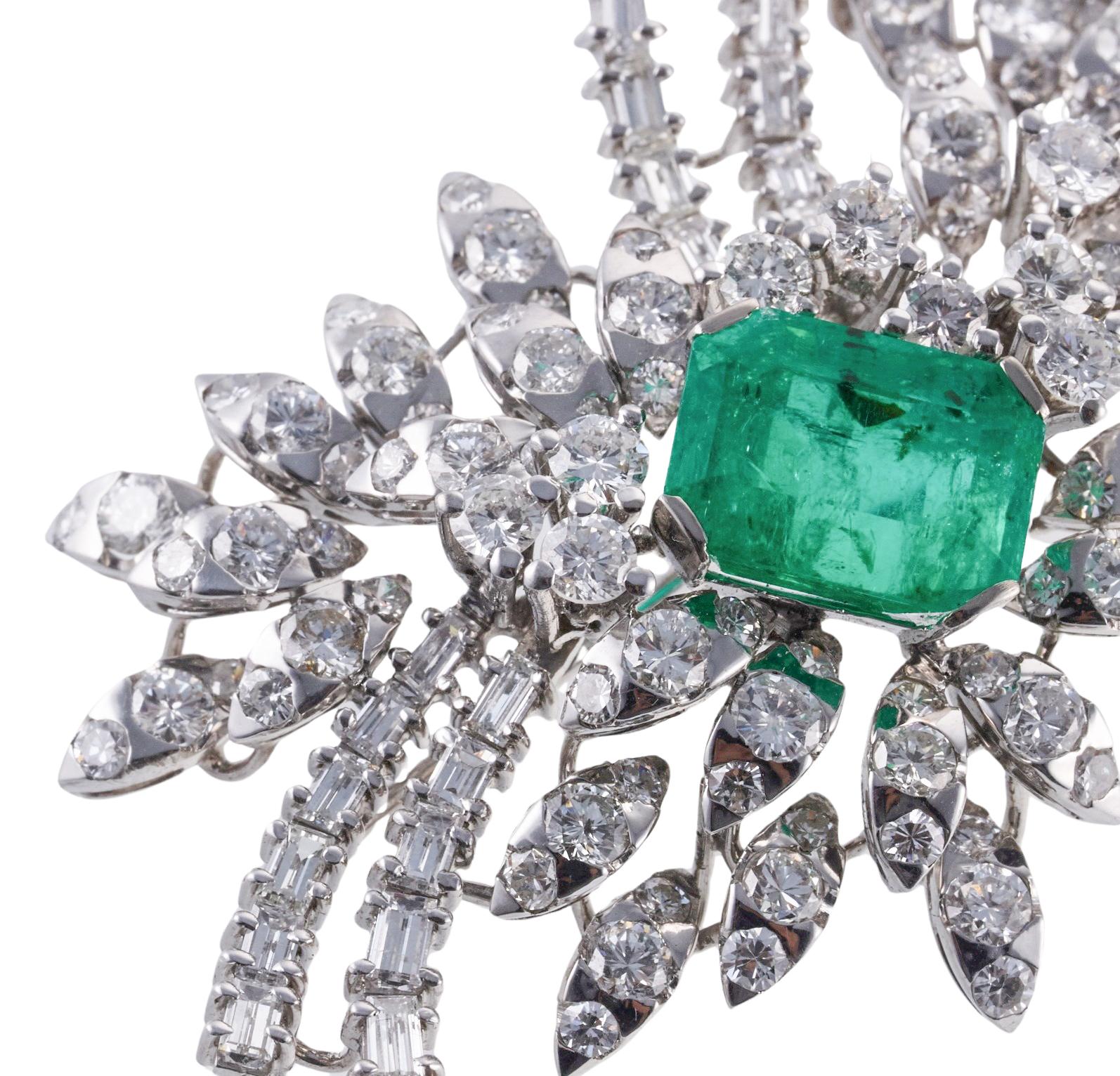 Impressive platinum brooch, set with center approx. 7.50ct emerald ( stone measures 13.4 x 10 x 7.7mm), surrounded with approximately 9-10 carats in H/Si1 diamonds.  Brooch measures 2 7/8