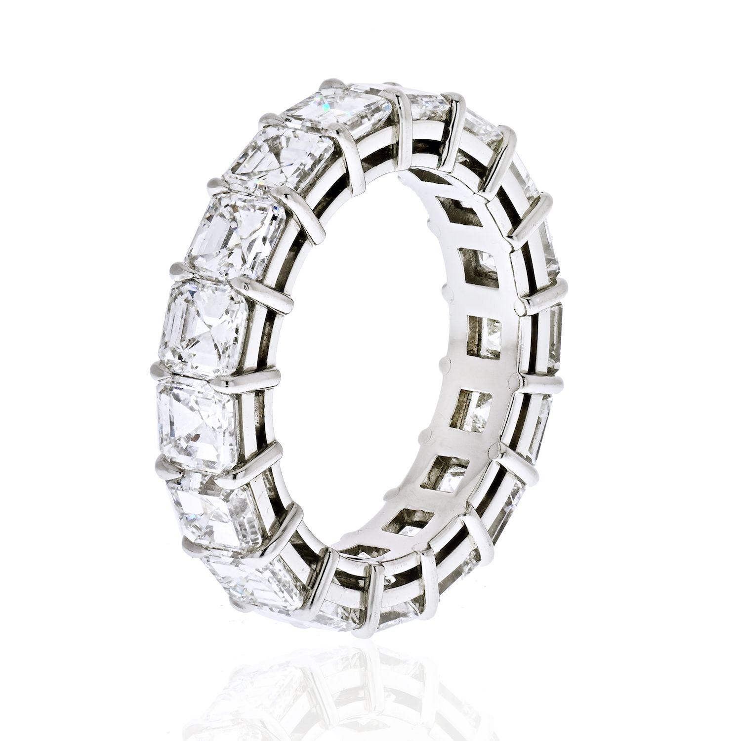 This is a superb, newly-crafted diamond eternity band rendered in rich platinum. Perfectly matched high-color, high-clarity asscher cut diamonds, totaling 7.65 carats, are each set individually within four secure prongs. This is a perfect match to
