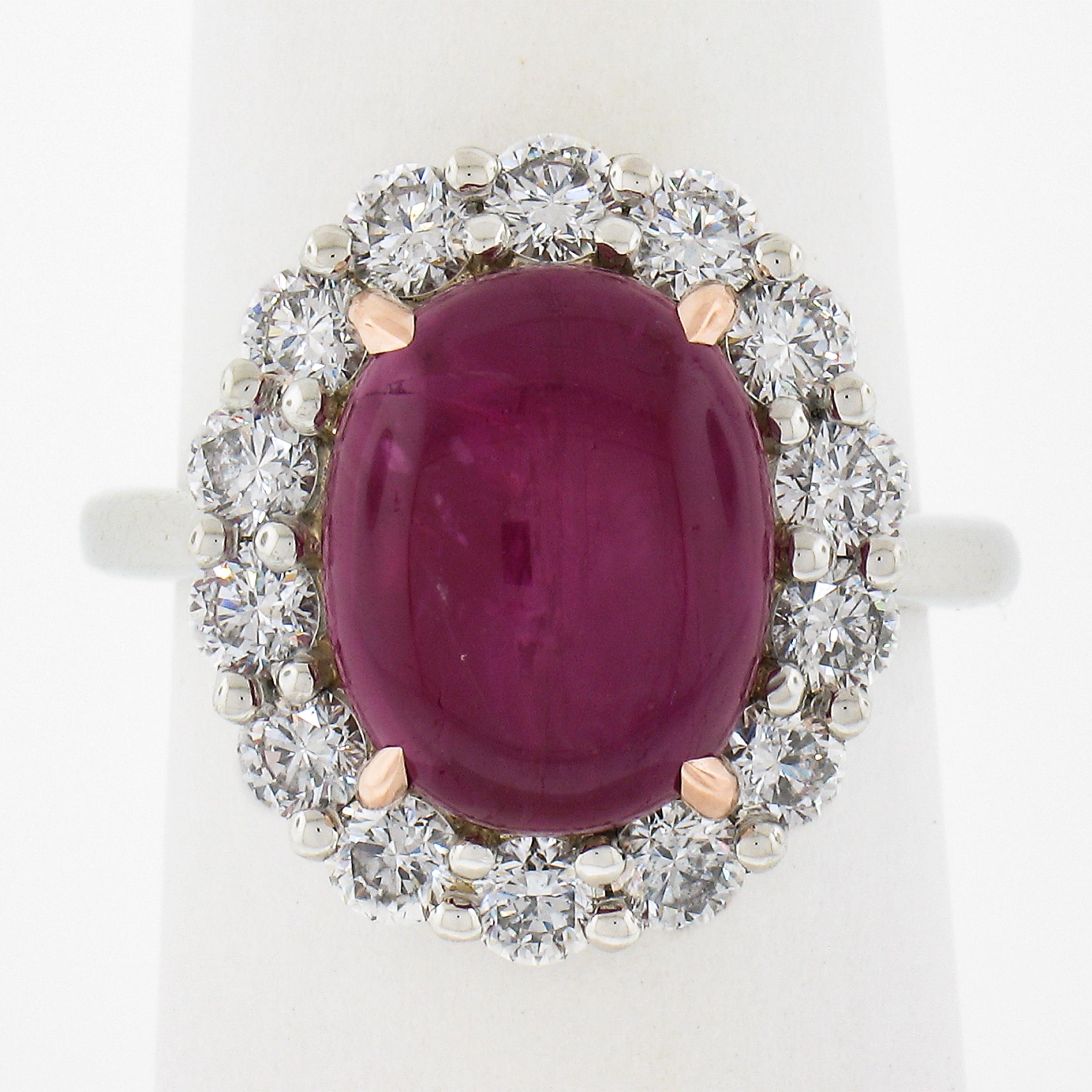 This elegant and attractive cocktail ring features a Burma origin ruby stone that displays truly attractive and eye catching purple-red color through its oval cabochon cutting style. It is surrounded by a halo of 14 large and super brilliant round