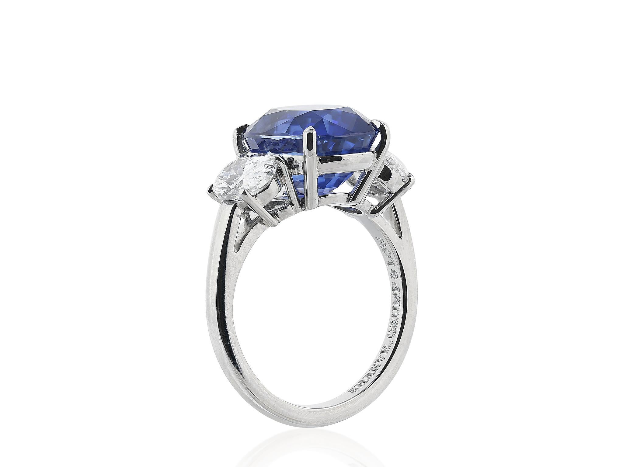 Platinum custom made 3 stone ring consisting of one oval shaped sapphire weighing 7.99 carats, the center stones is flanked by 2 oval brilliant diamonds having a total weight of 1.44 carats.