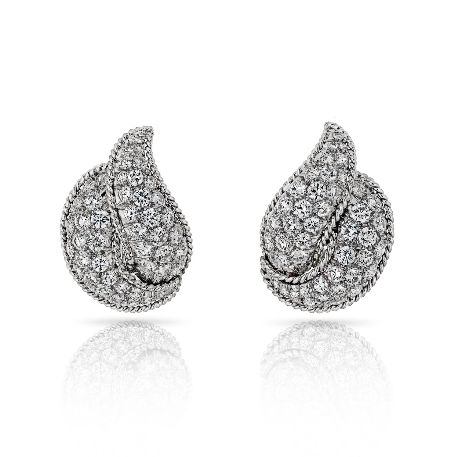 Step into the allure of the 1970s with these Circa Platinum 8.00 Carat Clip-On Diamond Earrings, a true embodiment of vintage glamour. The earrings boast a length of 25mm, allowing the soft leaf motif to gracefully frame your visage.

What makes