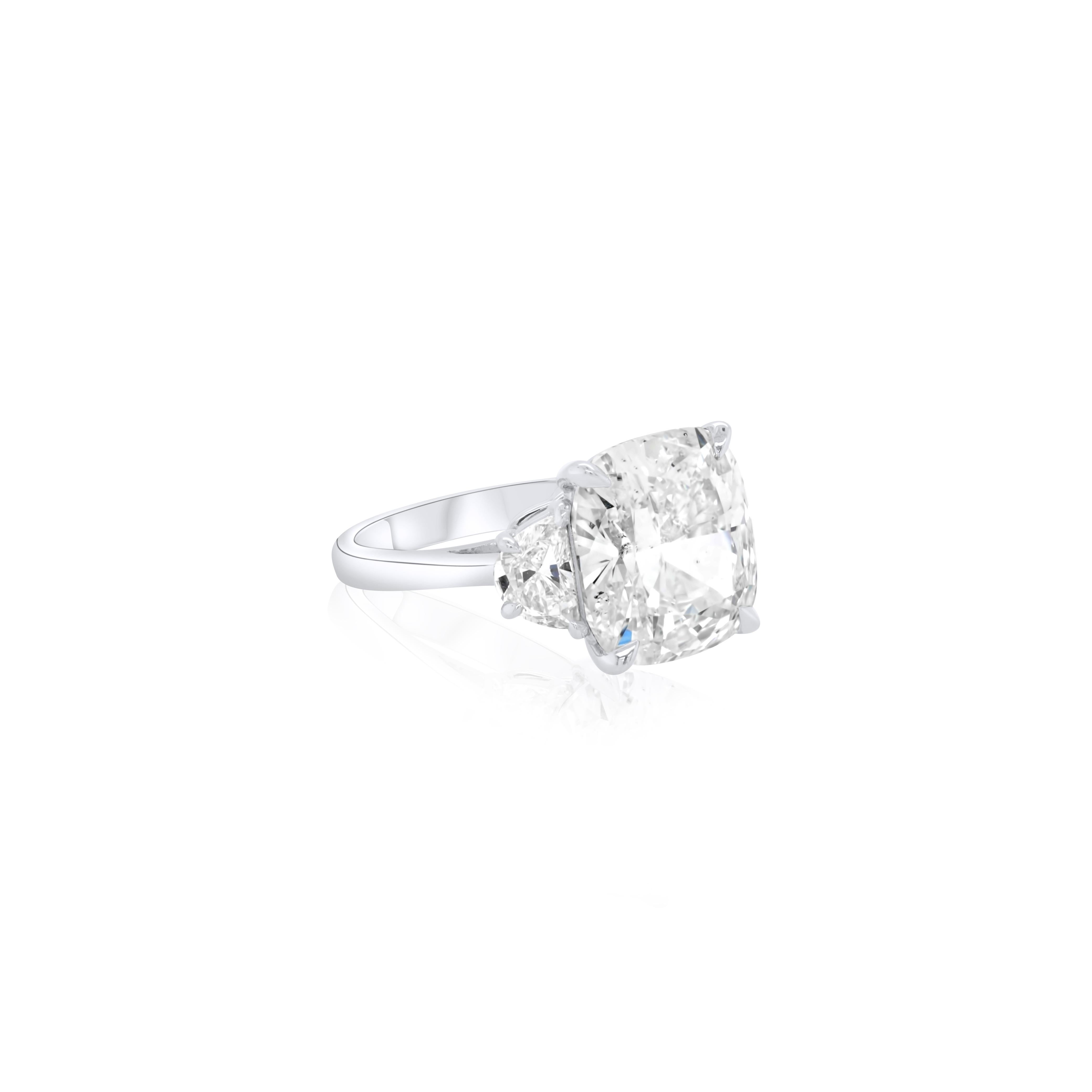 Platinum Three Stone Cushion Cut Diamond Ring, features 7.08 Carat Cushion Cut Diamond J Color SI2 in Clarity, set with two half moons with total diamond weight 1.01.
Certified by GIA  
