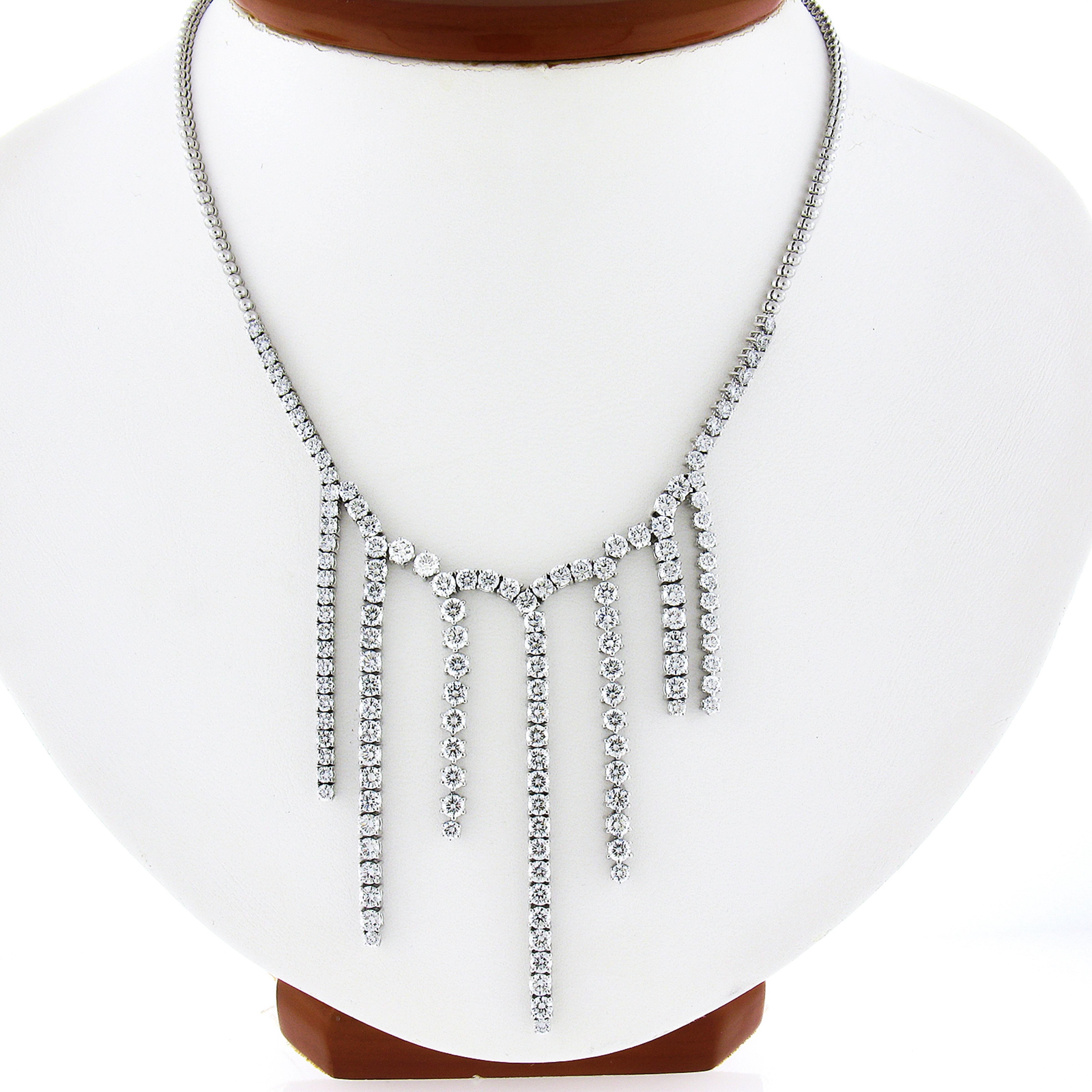 This fancy statement diamond necklace is very well crafted in solid platinum and features approximately 8.40 carats of very fine quality diamonds that are set in an incredible chandelier style that elegantly dangles across its center. These 135