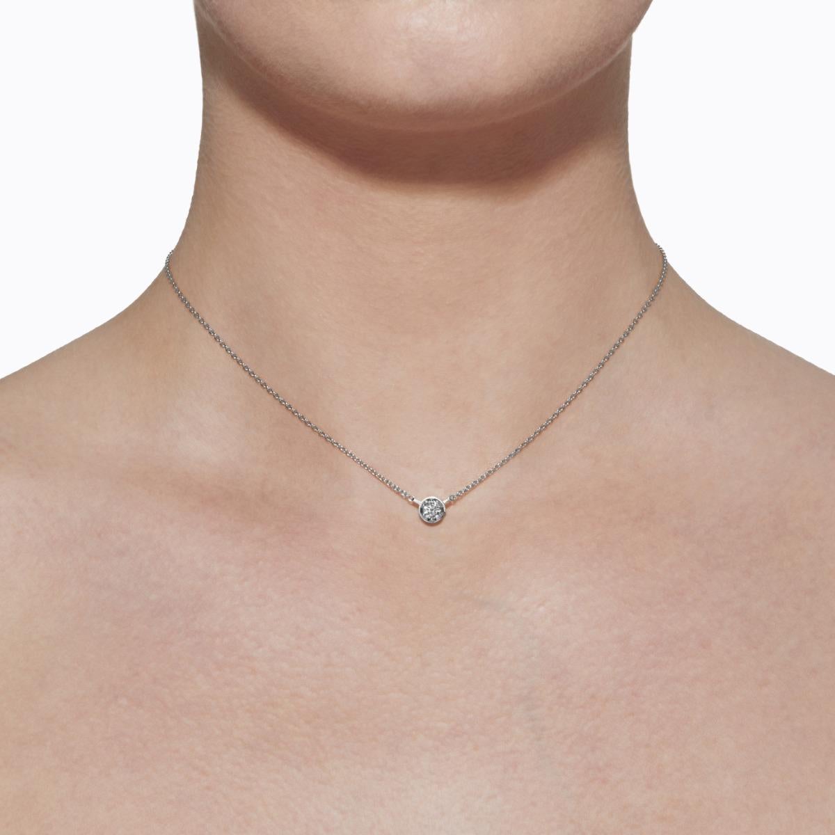 A single stone diamond necklace. Unlike traditional chain and pendant necklaces with a separate clasp, the diamond setting itself doubles as a hidden clasp, ensuring the stone is always featured in the front. Turn it horizontally 45 degrees to open