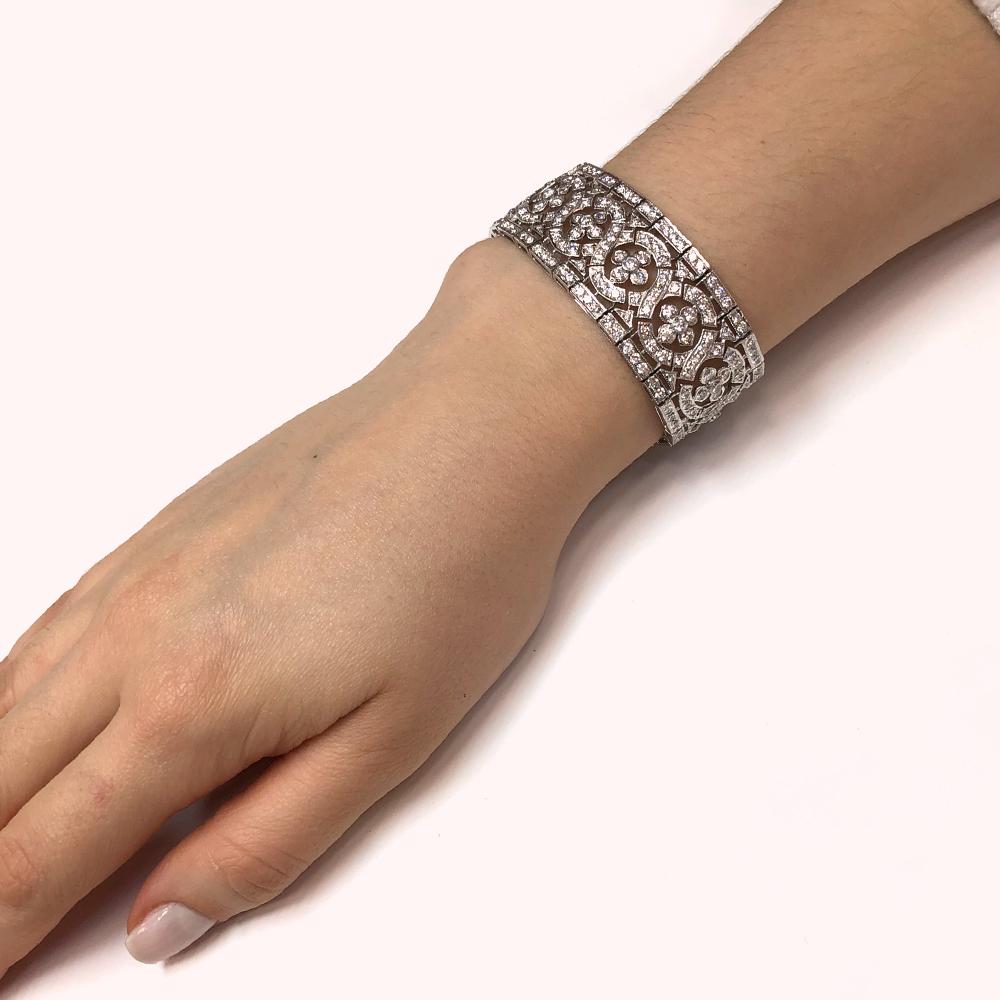 Wide vintage / retro inspired platinum 950 bracelet.
Adorned with round natural white diamonds 18.38 ct.
Diamonds in G-H color clarity VS.
Length: 17.5 cm
Width: 2.3 cm
Weight: 55 g