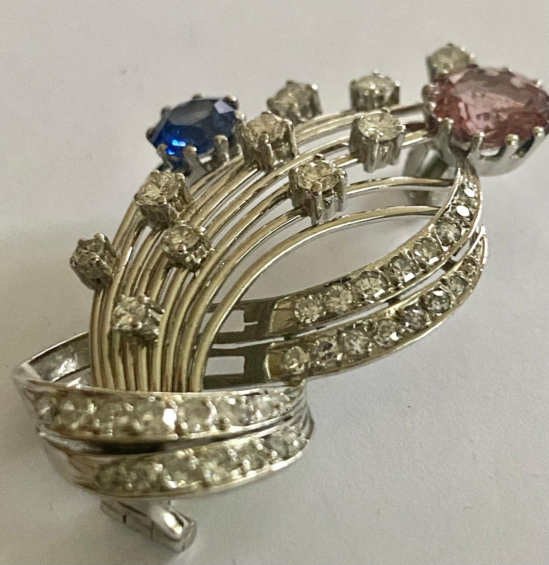 Platinum (960/-) Brooch
- Style: Art Deco ca 1930, made in Eastern Europe.
- Weight: 15.13 grams, size: 45 x 28 x 5 mm.
- 1 blue sapphire, weighing: 1.30 ct (untreated)
- 1 Rose Tourmaline, weighing 2.53 ct
- 40 diamonds in various cuts = approx.