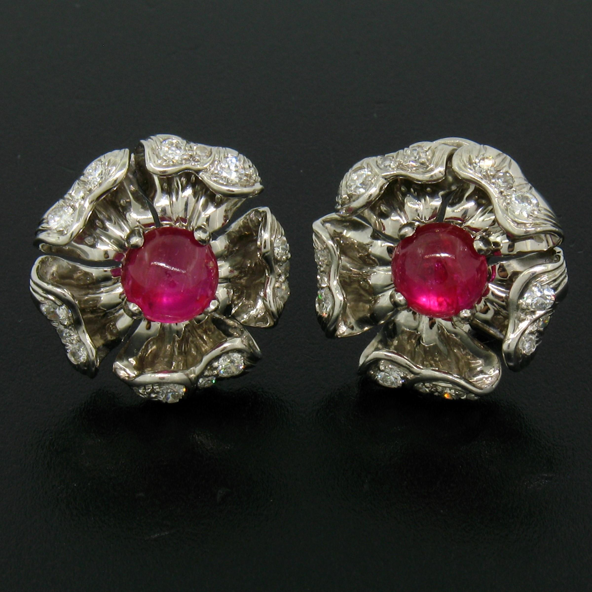 You are looking at a breathtaking pair of ruby and diamond earrings solidly and very well crafted in platinum. The ruby stones display very rich and desirable red color throughout their cabochon cut. Each stone is prong set at the center of the