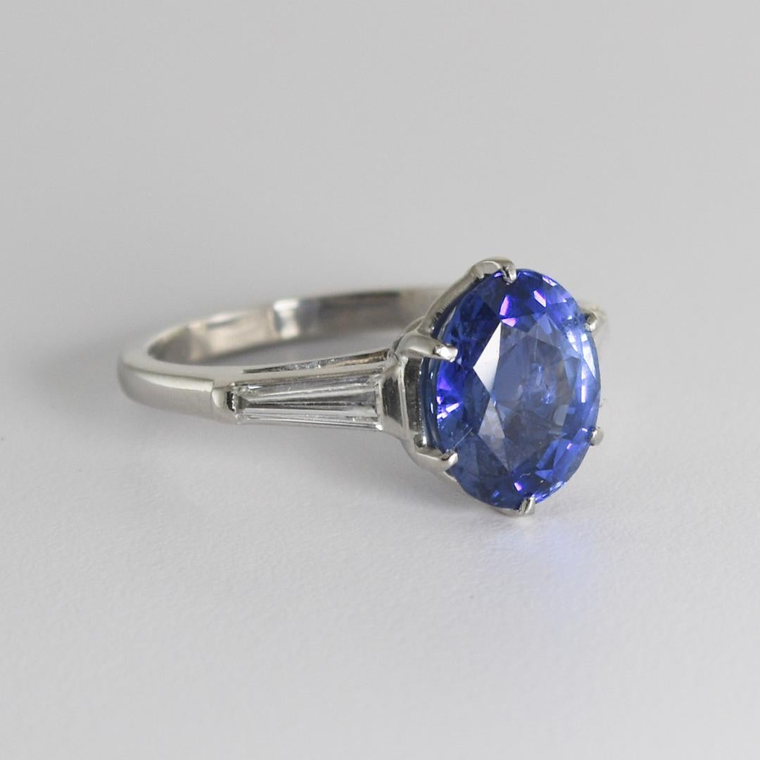 Ladies platinum and blue sapphire ring with diamonds.
Stamped 10% Irid, Plat. and weighs 6.9 grams.
Tests 90% platinum with an XRF metals analyzer.
The Ceylon sapphire is oval shaped with a mixed cut, 4.60 carats, violet-blue color.
Graded by