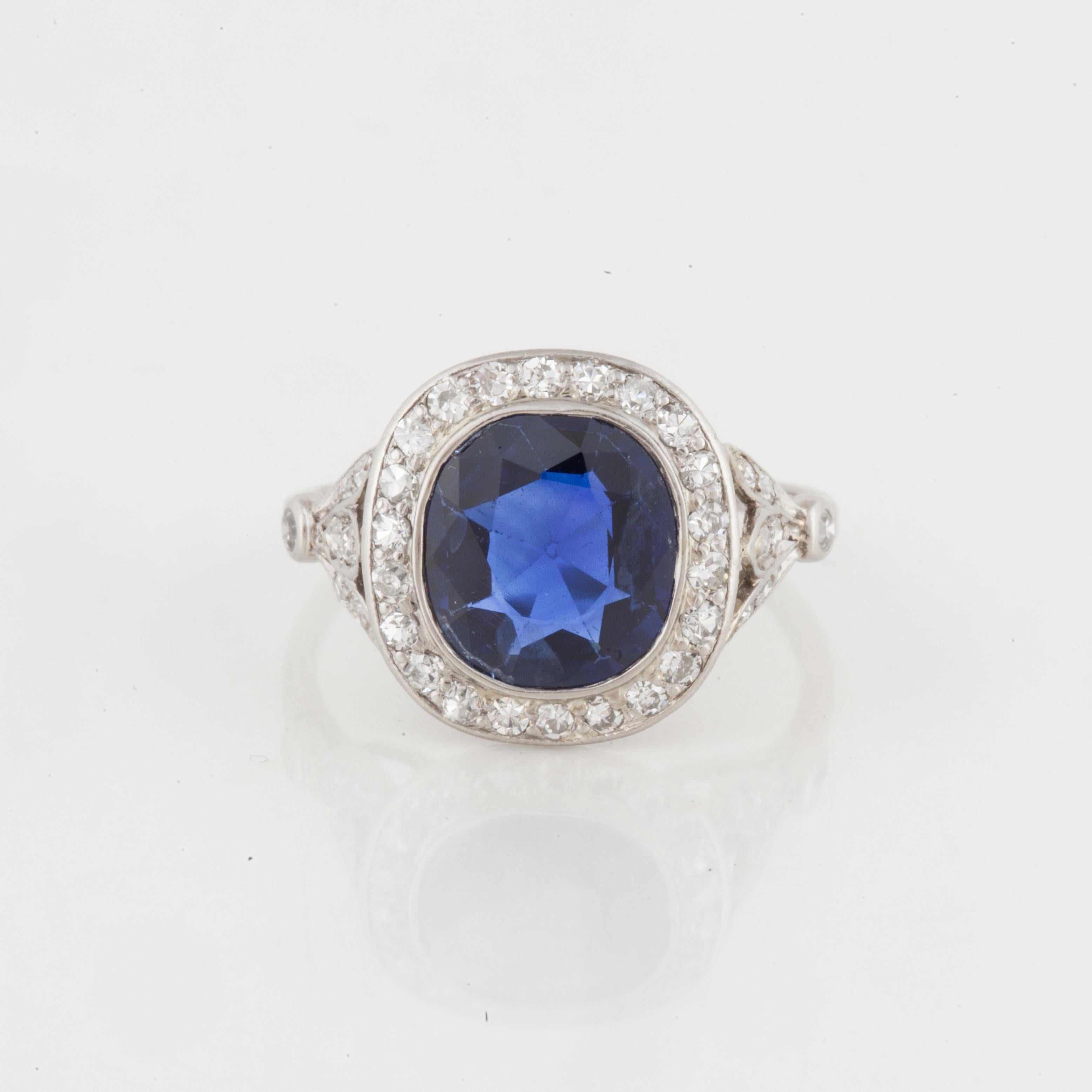This ring features a natural blue sapphire accented by round diamonds set in platinum.  The oval sapphire weighs 2.24 carats, with no enhancements, and accompanied by an AGL report.  The sapphire is accented by thirty-six (36) single-cut diamonds
