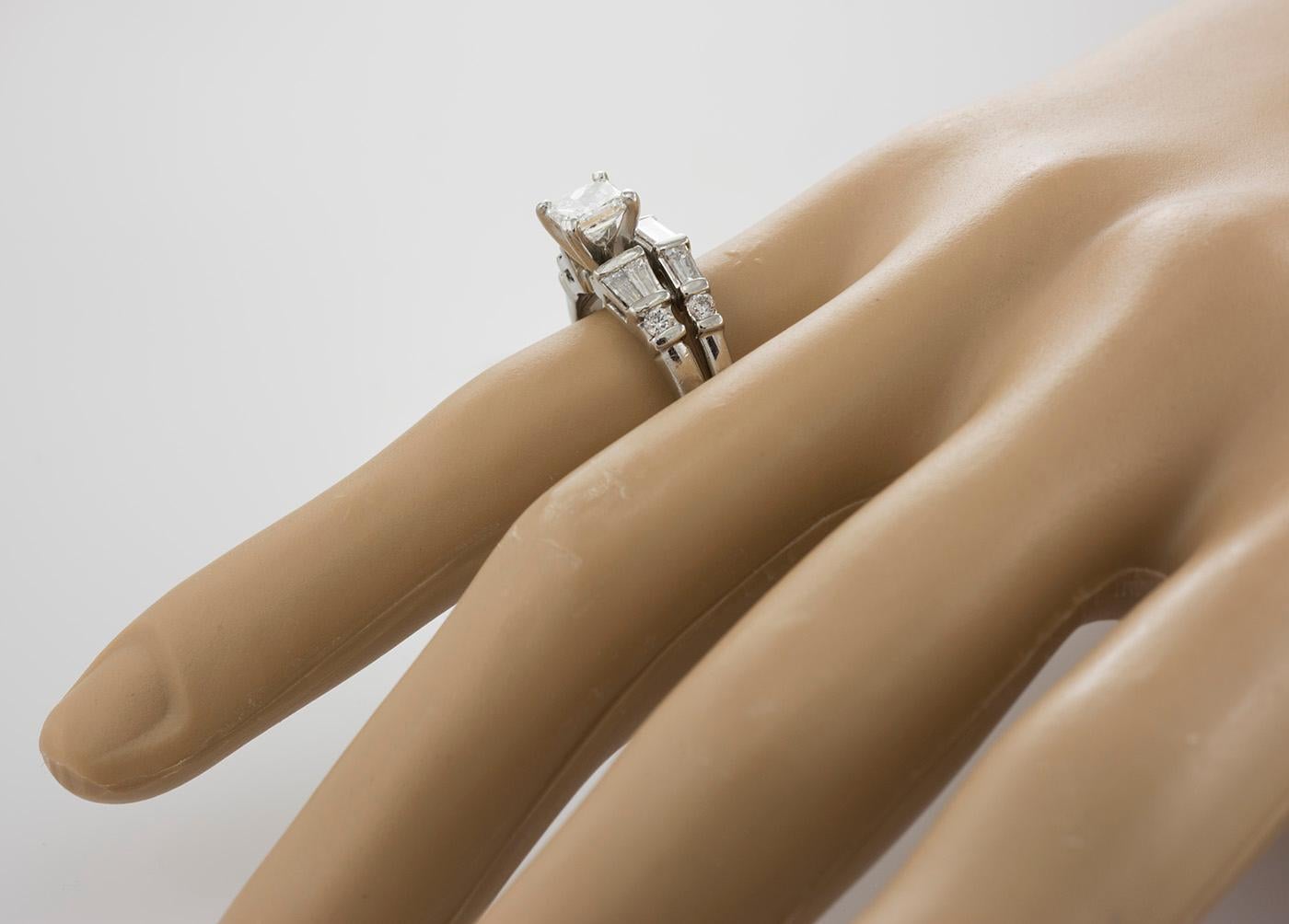 Ladies Platinum Wedding Ring Set With Diamonds.
Marked Platinum And Weighs 8.5 Grams.
The Center Stone Is A Square Shaped Princess Cut, .70 Carat, G Color, I1 Clarity with AIG Grading Certificate.
The Diamond Faces Up Very Nicely And Looks Better