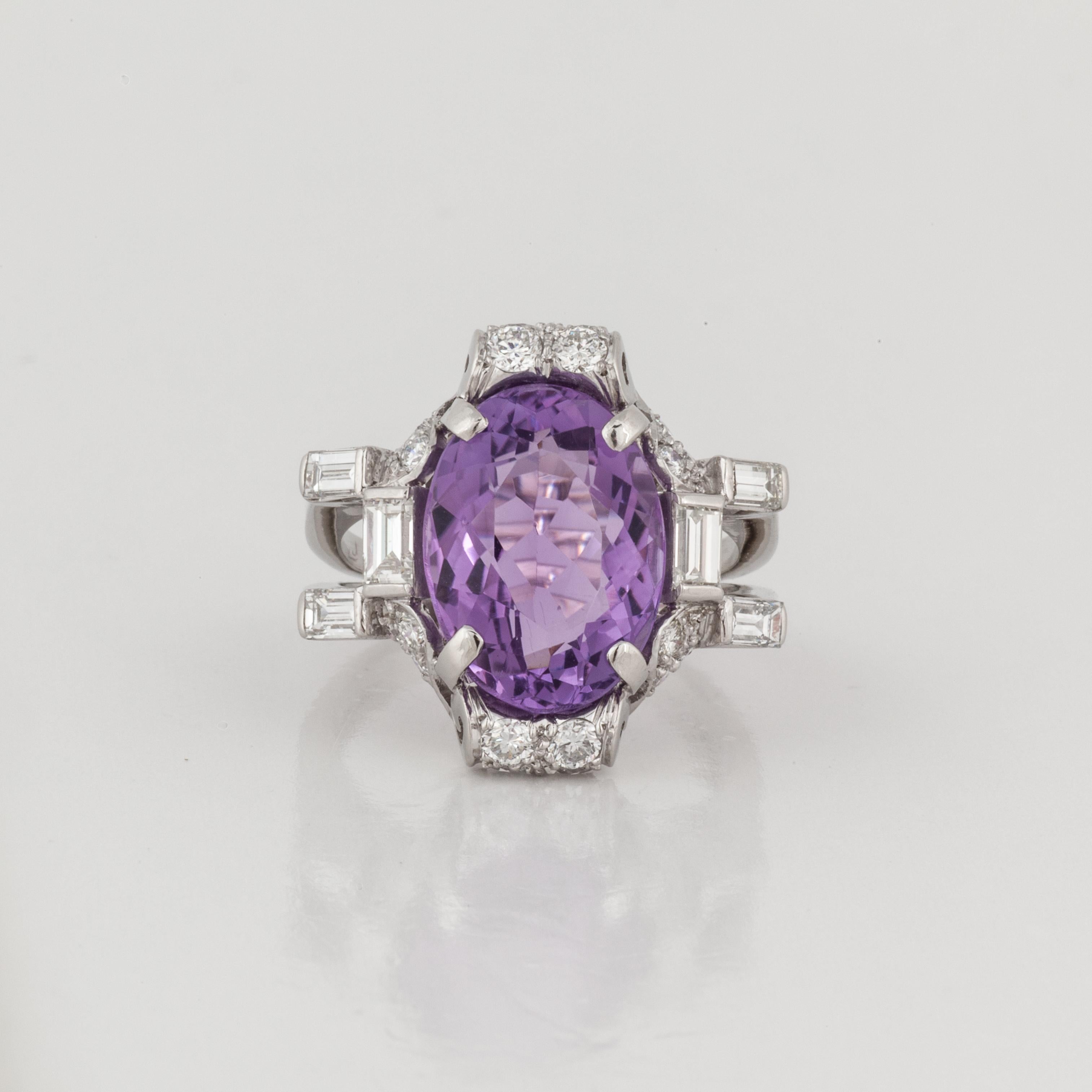 Platinum ring featuring an oval amethyst accented by round and baguette diamonds.  The amethyst weighs 7 carats.  Surrounding the amethyst 20 round diamonds totaling 0.65 carats and six baguette diamonds that total 0.60 carats, H-I color and VS