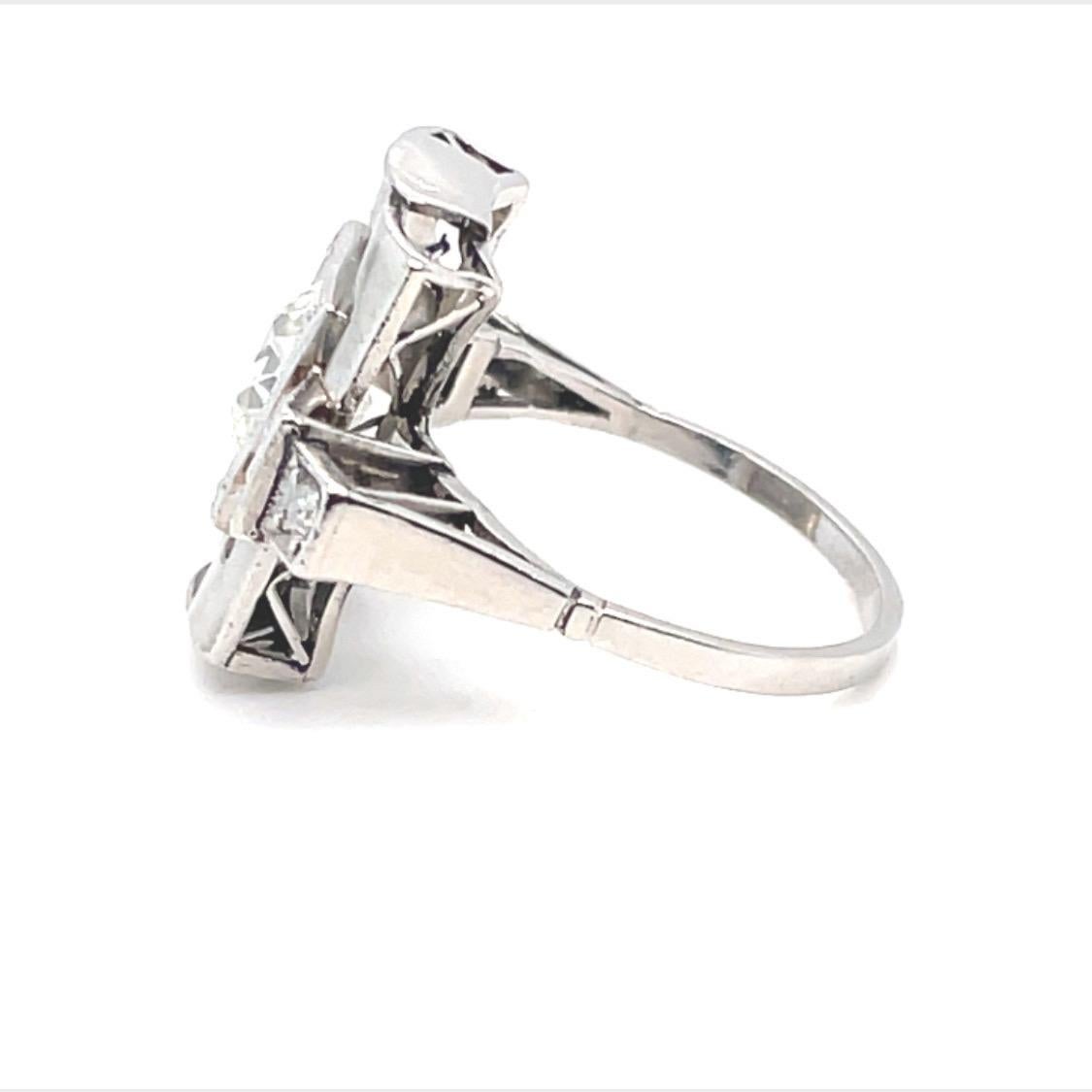 Architectural platinum and diamond Art-Déco ring dating circa 1925.

Art-Déco ring of open-work, geometric design, centering upon 1 old European cut diamond of circa 1.4 carats, in mille-grain setting, flanked by two circular- and two single-cut
