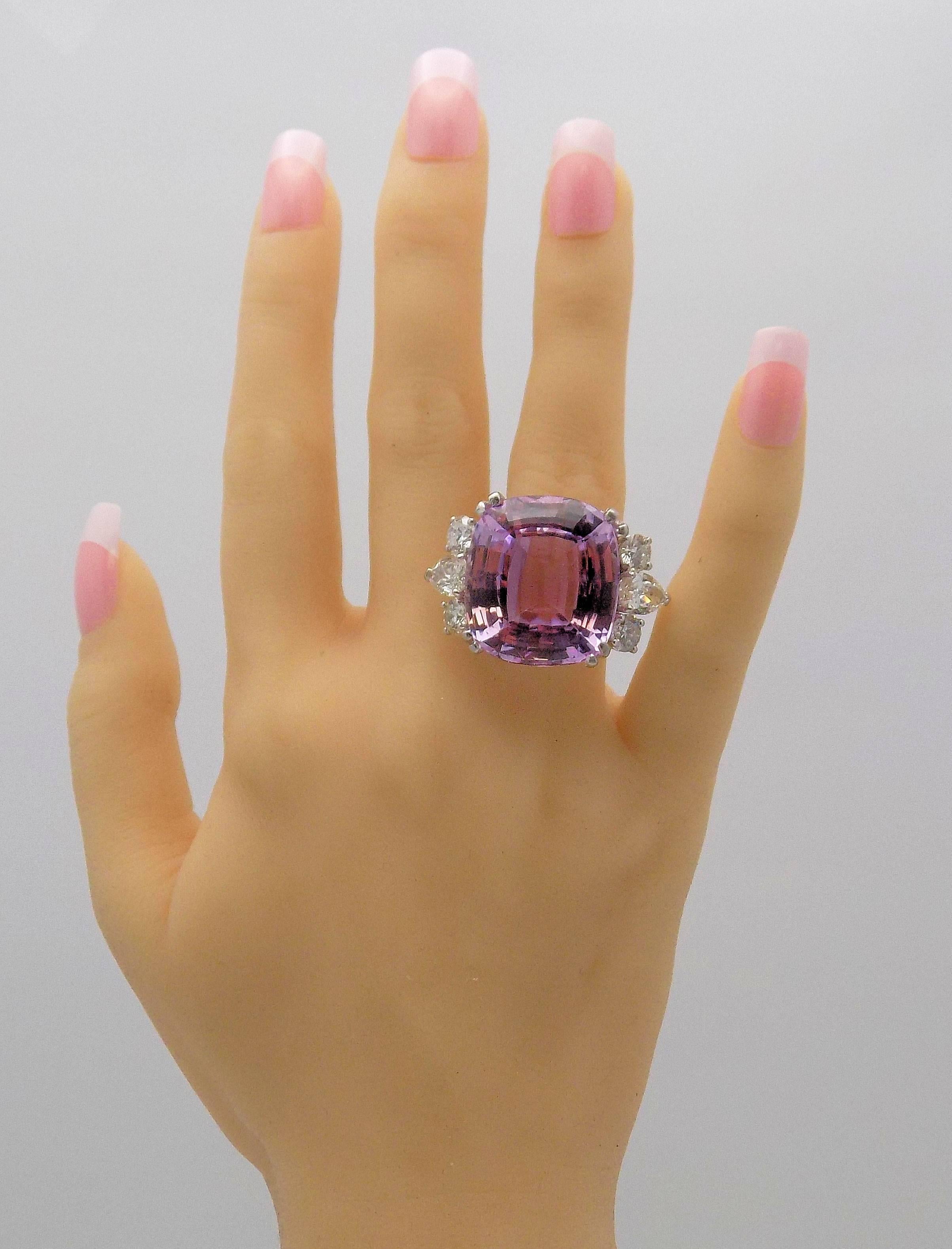 Platinum and 14 Karat White Gold Ring Featuring 1 Cushion Cut Kunzite 45.6 Carat; 2 Pear Shape Diamonds and 4 Round Diamonds totaling 4 Carat Total Weight SI2 - 2I3, H-J; Finger Size 7.5; 15.4 DWT or 23.95 Grams.