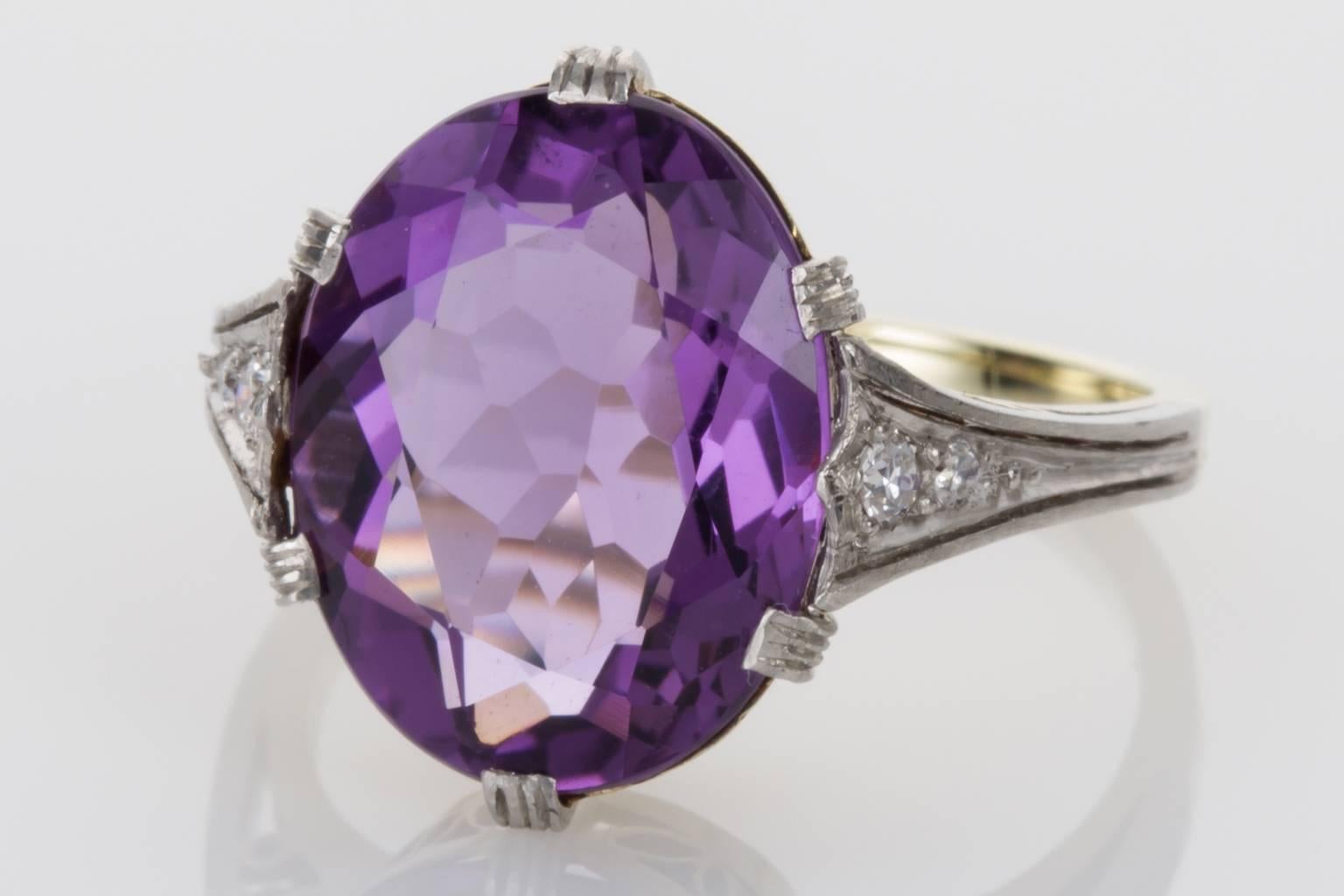 A beautiful ring with a pretty purple oval amethyst as its centrepiece. The amethyst shows gorgeous tones of lilac and purple and has a sparkle due to the cutting of the gemstone. Mounted in platinum and 14kt yellow gold the undergallery has fine