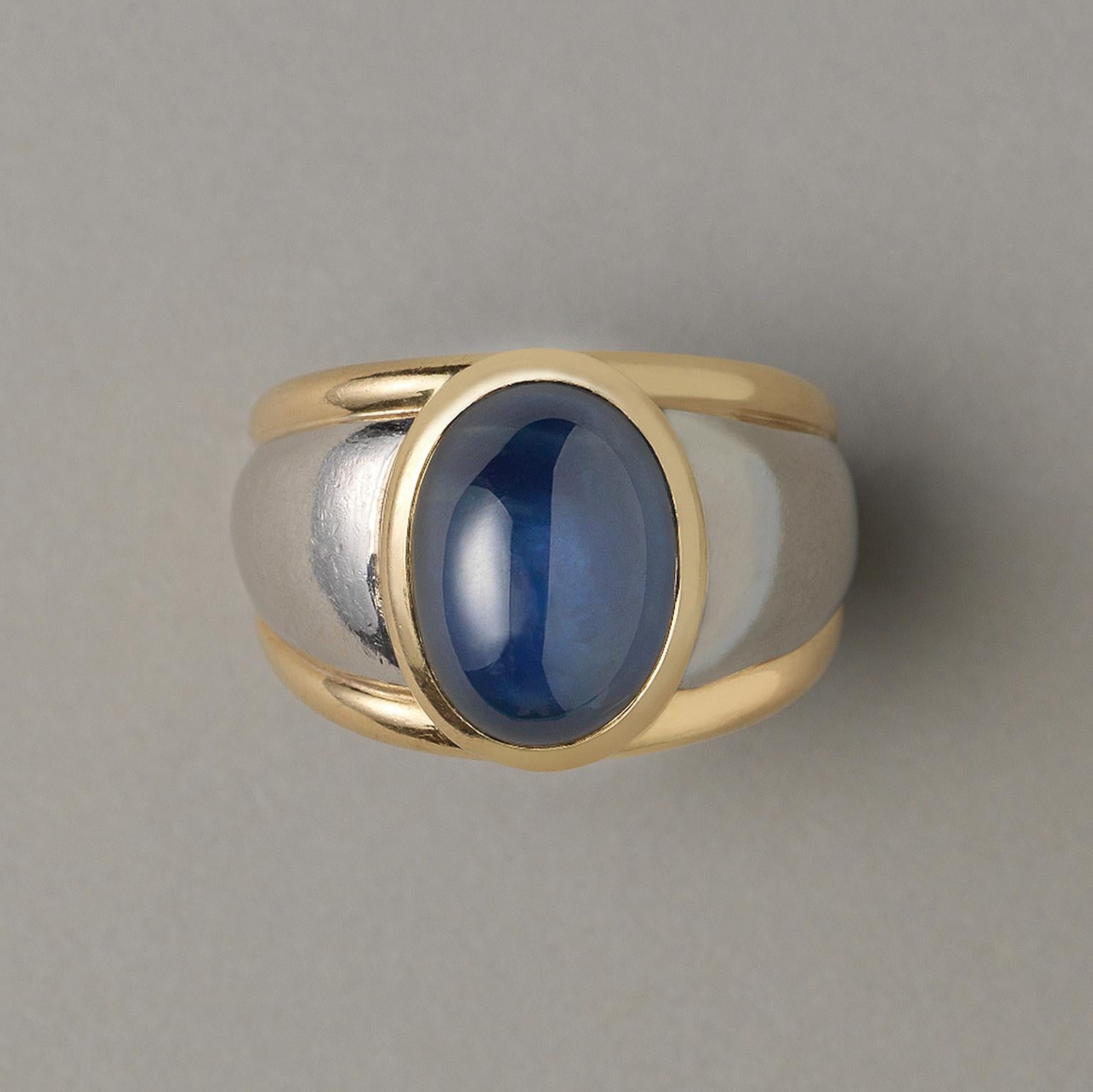 A large platinum and 18 carat yellow gold ring set with an oval cabochon cut natural untreated sapphire (app. 11.87 carat), France.

ring size: 18.25 mm / 8 US
weight: 18.54 grams