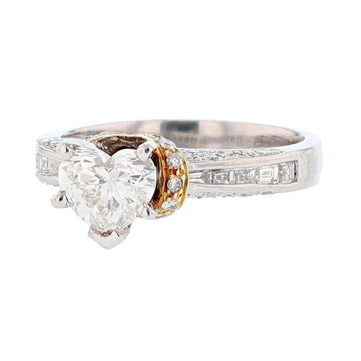 This ring is made in Platinum and 18 Karat Yellow Gold featuring a Heart Shaped Diamond. The center diamond is a 0.91 carat GIA certified Heart Shape Diamond with a color grade (H) and clarity grade (VS1). The certificate number is 