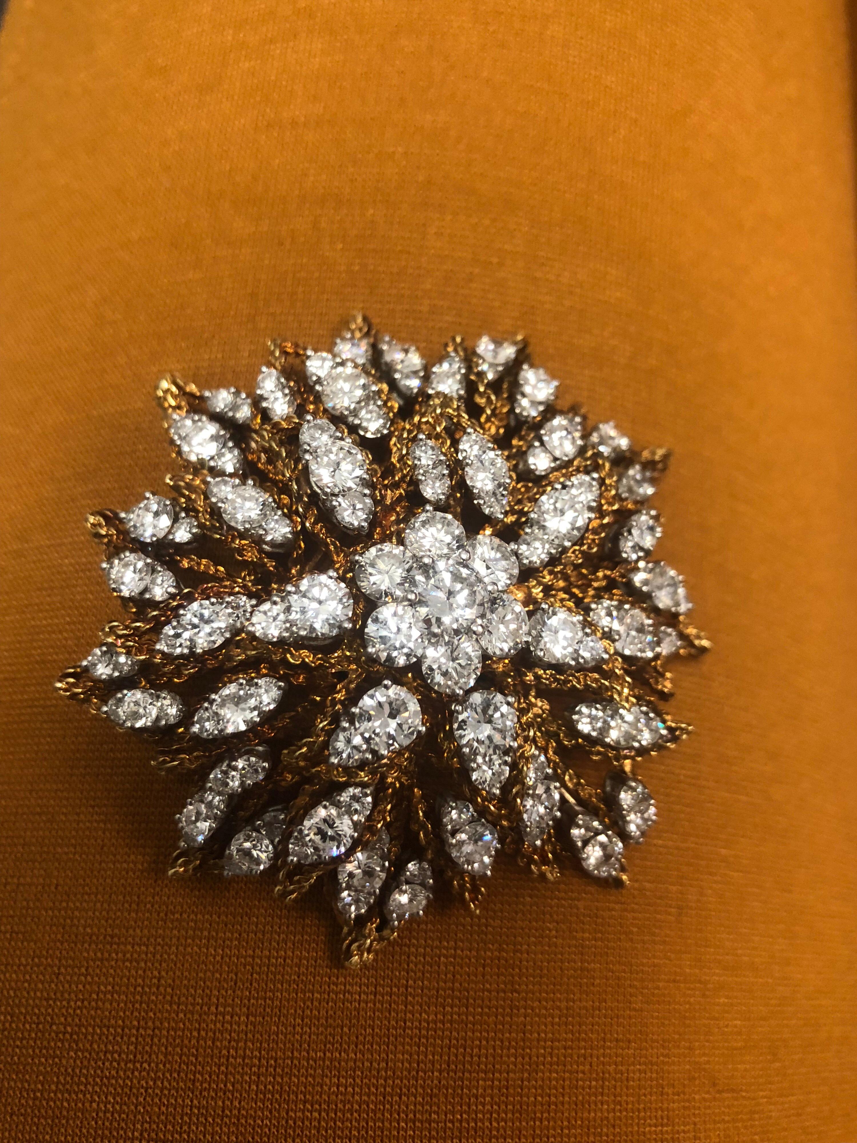 Circa 1960 Platinum and 18k yellow gold sunburst design brooch with diamonds. This immaculate brooch features 122 diamonds weighing 20.70 carats total. 
