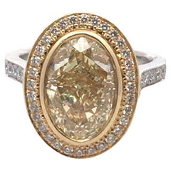GIA 5.02 carat Platinum and 18 Karat Yellow Gold Fancy Light Yellow Diamond Ring