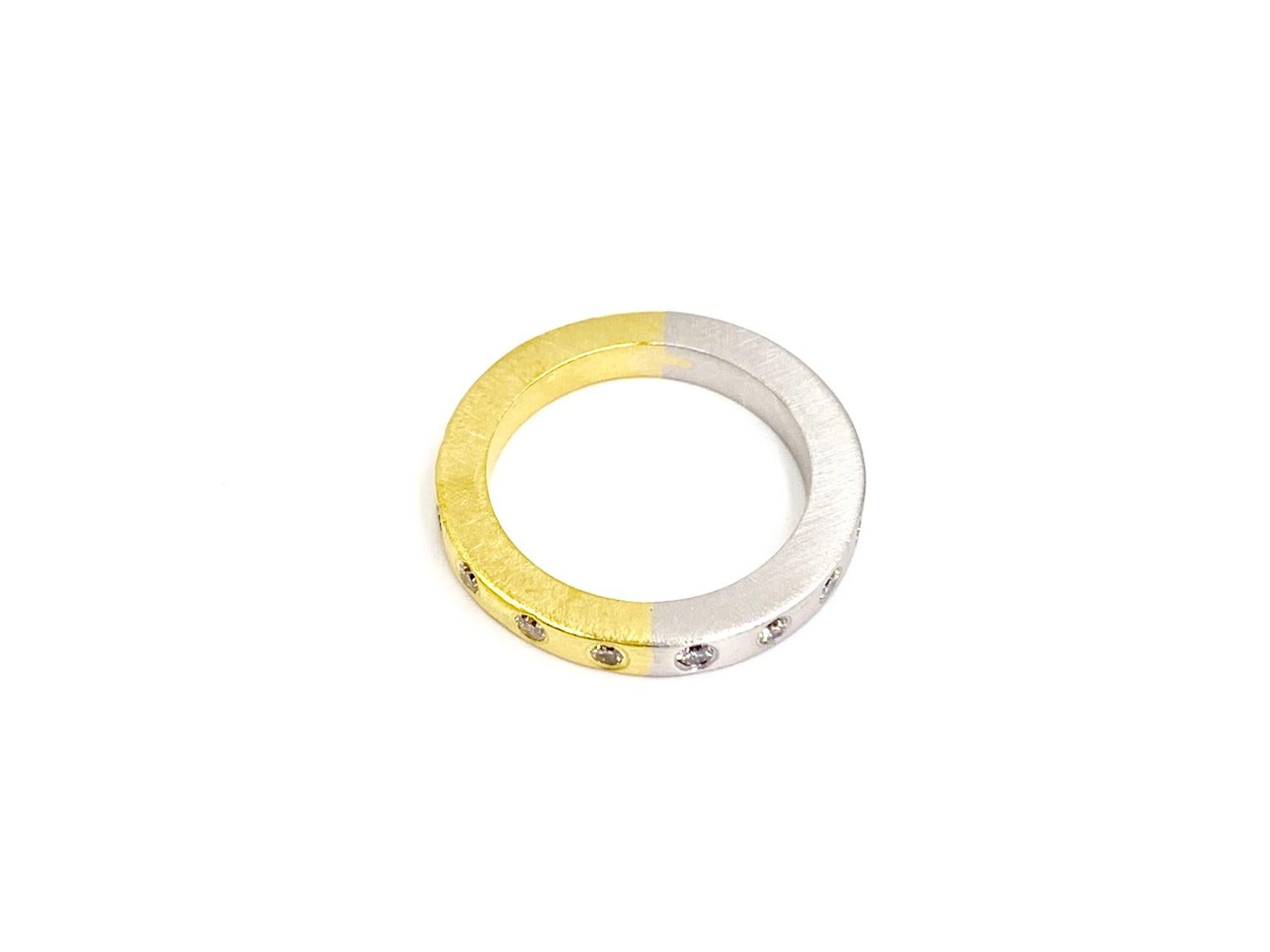 A clean, modern and well crafted solid platinum and 18 karat yellow gold 3mm satin finished band featuring 16 burnished round brilliant diamonds at .40 carats total weight. Diamond quality is approximately F color, VS2 clarity (colorless, eye