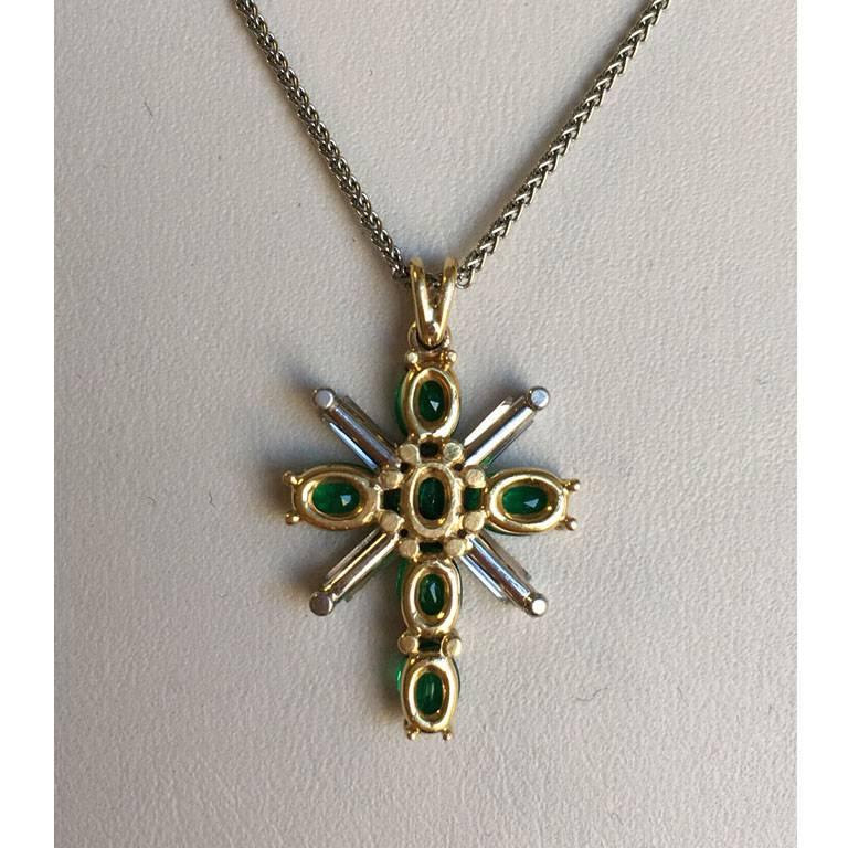 Platinum and 18Kt Yellow Gold Emerald and Diamond Cross Pendant on Chain. 

Handmade (one of a kind).
6 oval-shaped emerald (estimated weight 1.34ct total)
4 straight diamond baguettes, quality VVS, color E  (estimated weight 0.48ct total)

Pendant