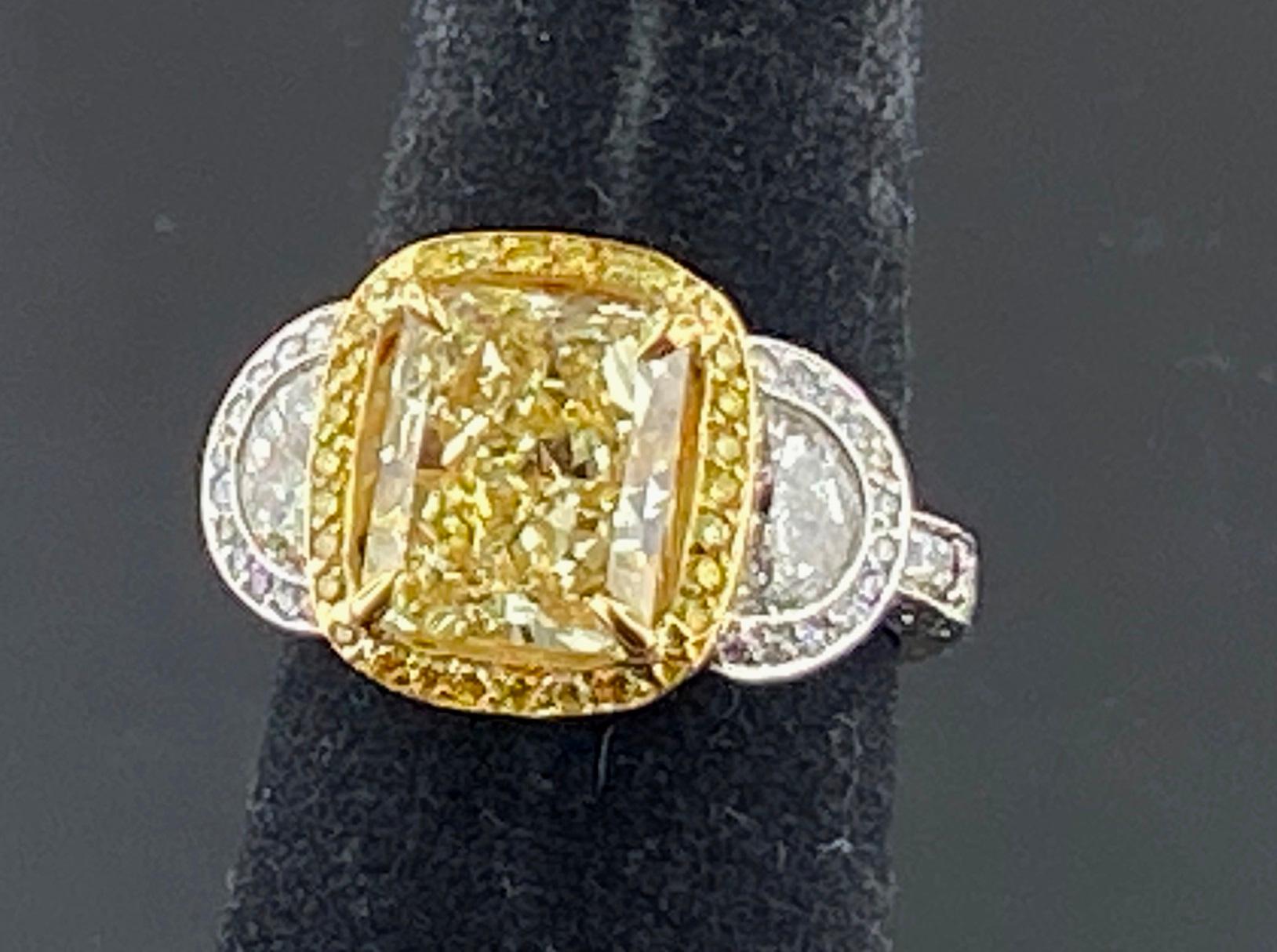 Set in Platinum and 18 karat yellow gold, weighing 11 grams, is a 3.74 carat Radiant Cut Fancy Yellow diamond, Clarity Grade of: VVS-2.  Surrounding the center diamond are 88 Fancy Yellow Round Brilliant Cut diamonds with a total weight of 0.45